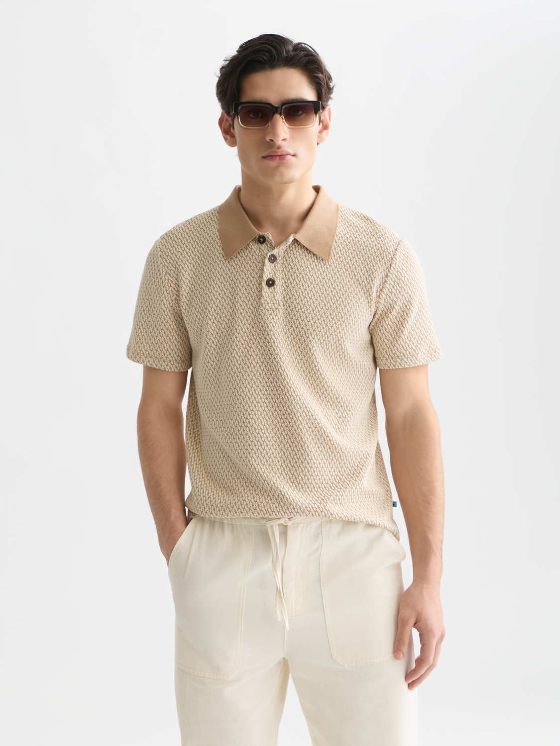 SCOTCH & SODA jacquard polo shirt featuring intricate woven pattern, classic collar, and short sleeves.