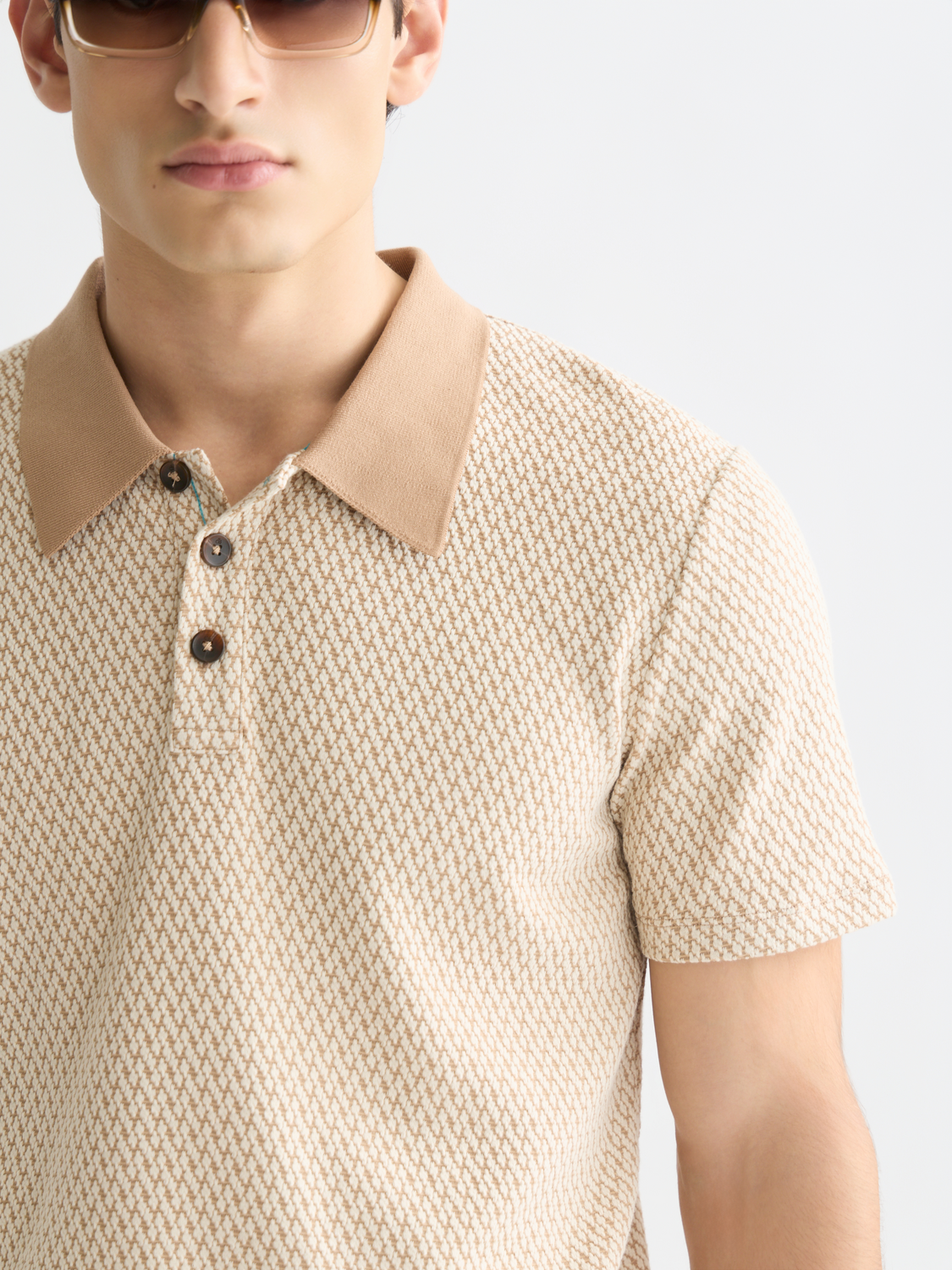 SCOTCH & SODA jacquard polo shirt featuring intricate woven pattern and classic collar, displayed on a neutral background.
