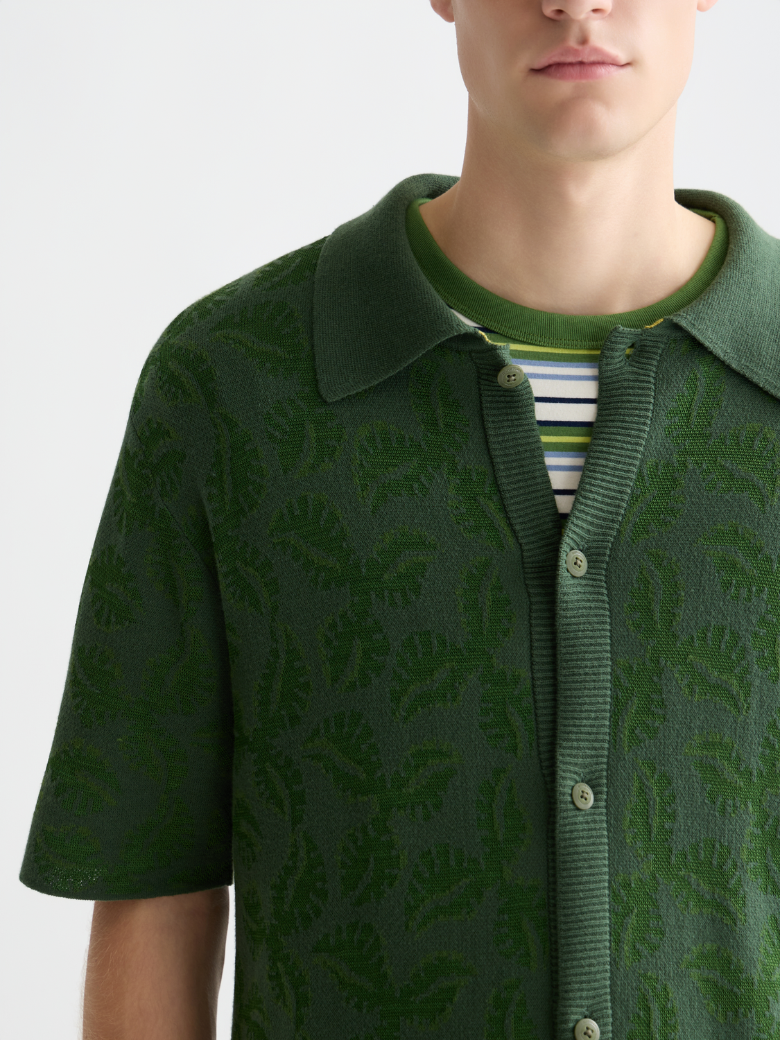 Knitted jacquard short-sleeved shirt by Scotch & Soda featuring intricate knit pattern and short sleeves.