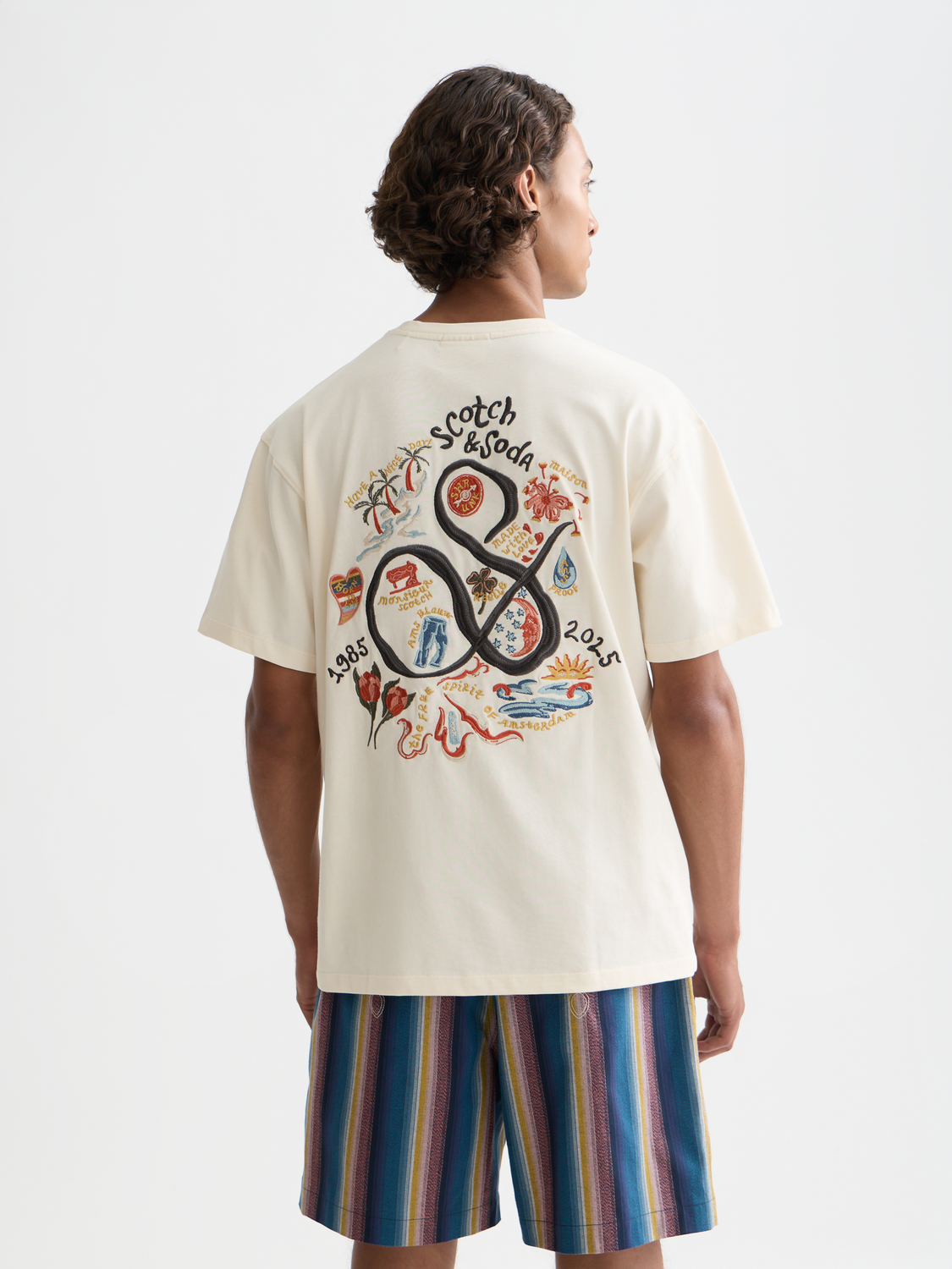 Black short-sleeve Scotch & Soda embroidered t-shirt with colorful floral design on the front.