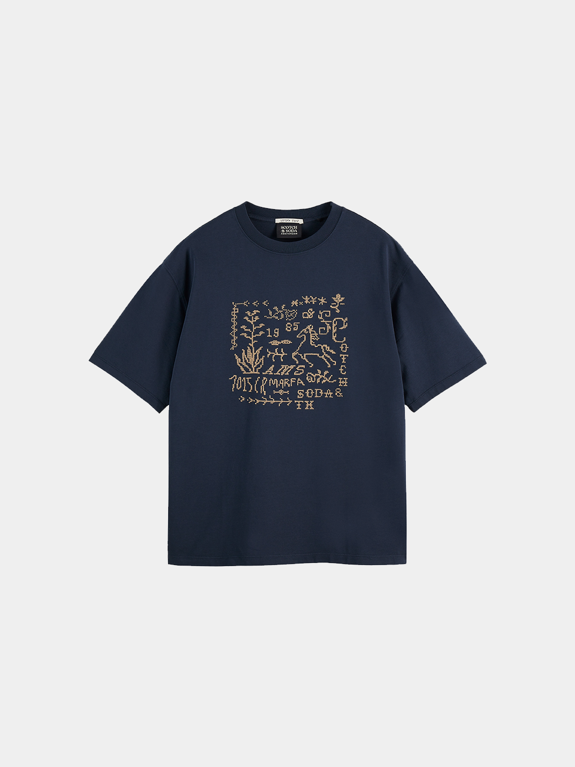 Short sleeve Scotch & Soda t-shirt with cross-stitched artwork design, featuring colorful embroidered details on a casual fabric.