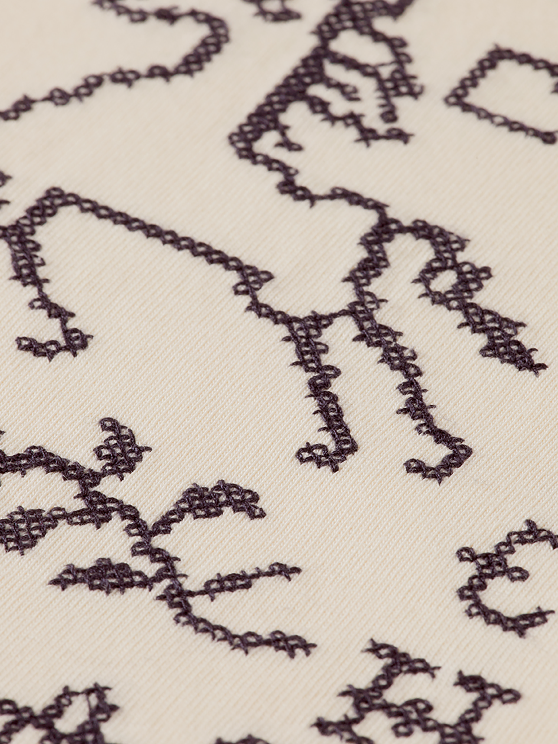 Short sleeve T-shirt by Scotch & Soda featuring cross-stitched artwork design on soft fabric.
