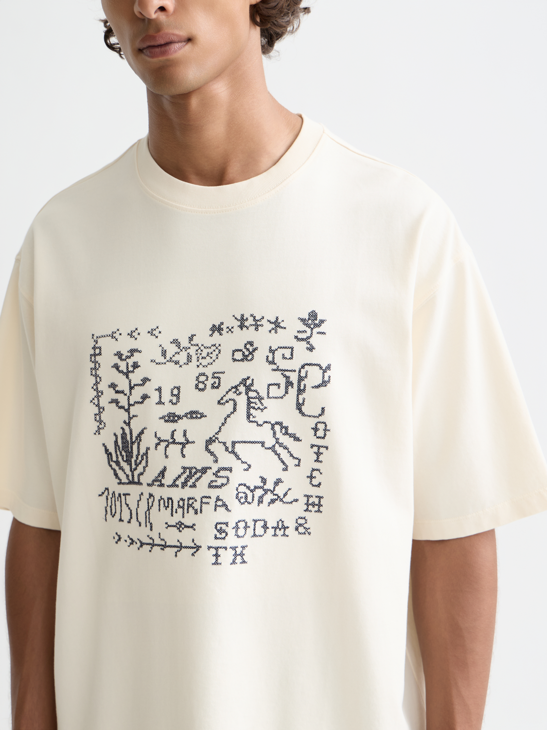 Short sleeve Scotch & Soda tee featuring cross-stitched artwork design on the front.