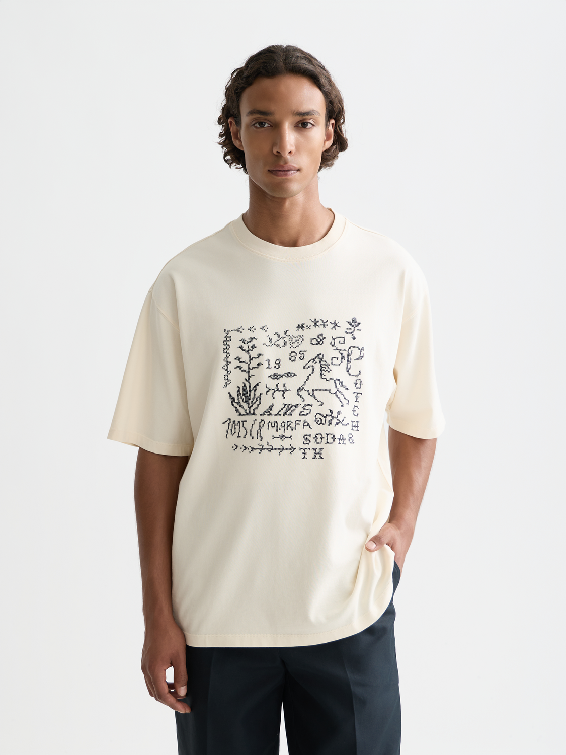 Short sleeve Scotch & Soda t-shirt featuring detailed cross-stitched artwork on the front.
