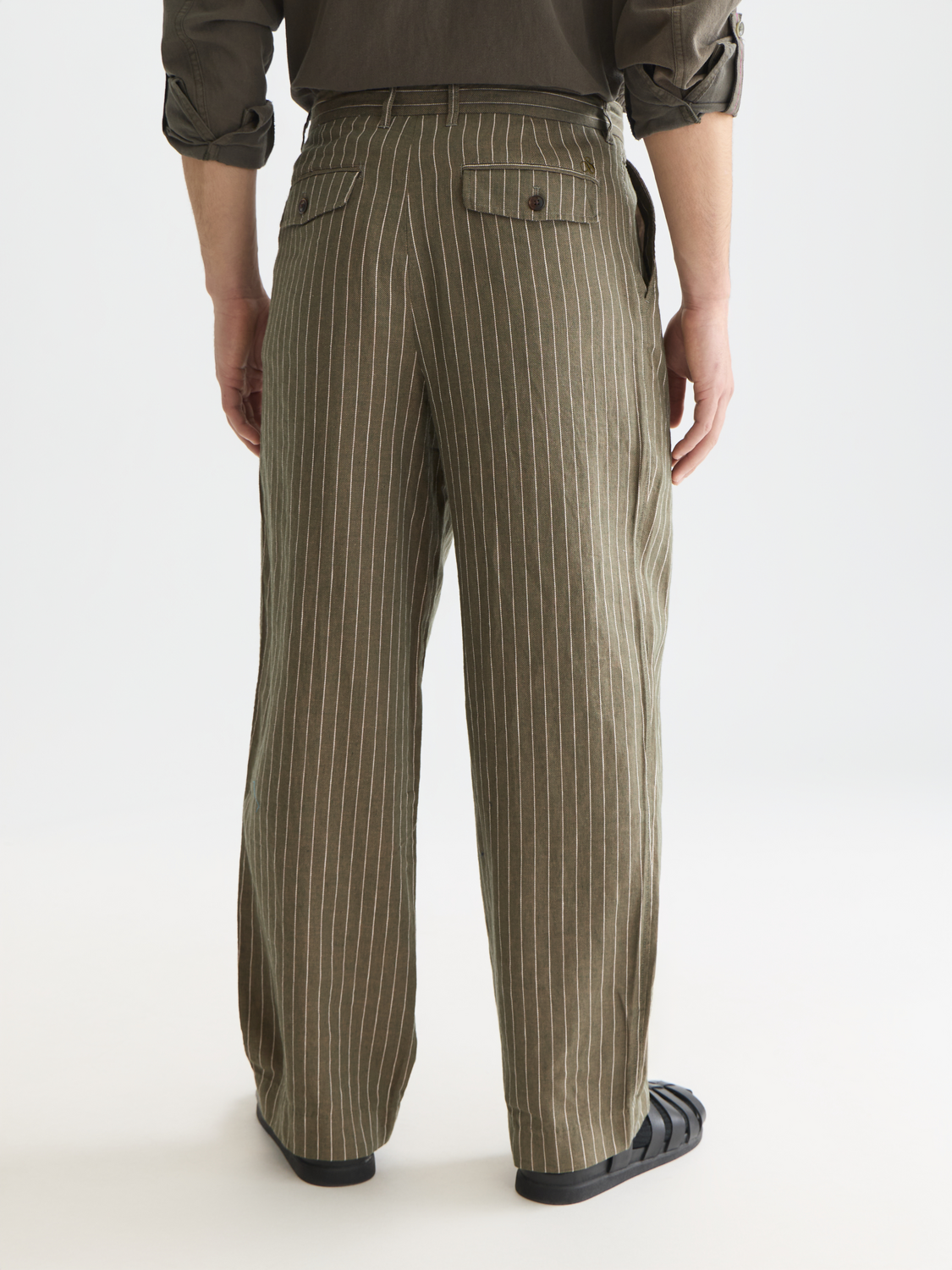 Scotch & Soda pleated pinstriped chino pants with back pockets, shown from the rear view.