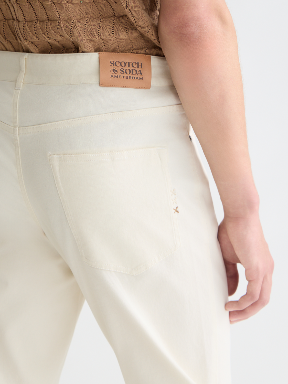 SCOTCH & SODA Ralston slim-fit 5-pocket pants in dark denim, showing front view with pockets and belt loops.