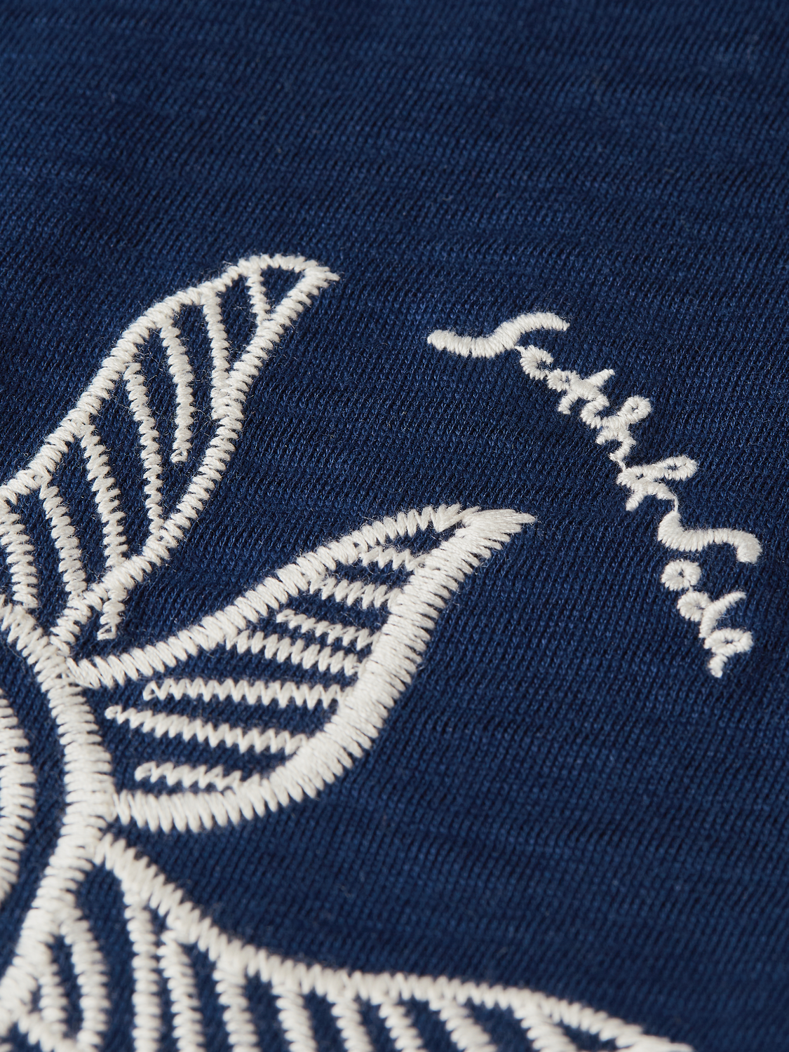Light-colored Scotch & Soda short-sleeve artwork T-shirt featuring a creative graphic design on the front.