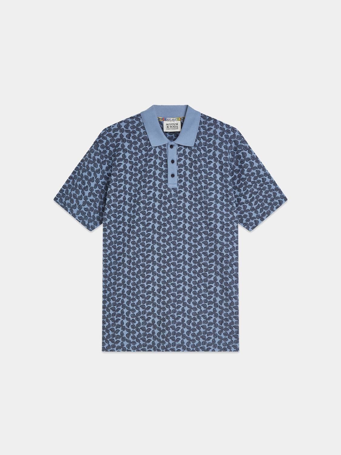 Printed polo shirt by Scotch & Soda featuring a colorful pattern, collared neckline, and short sleeves.