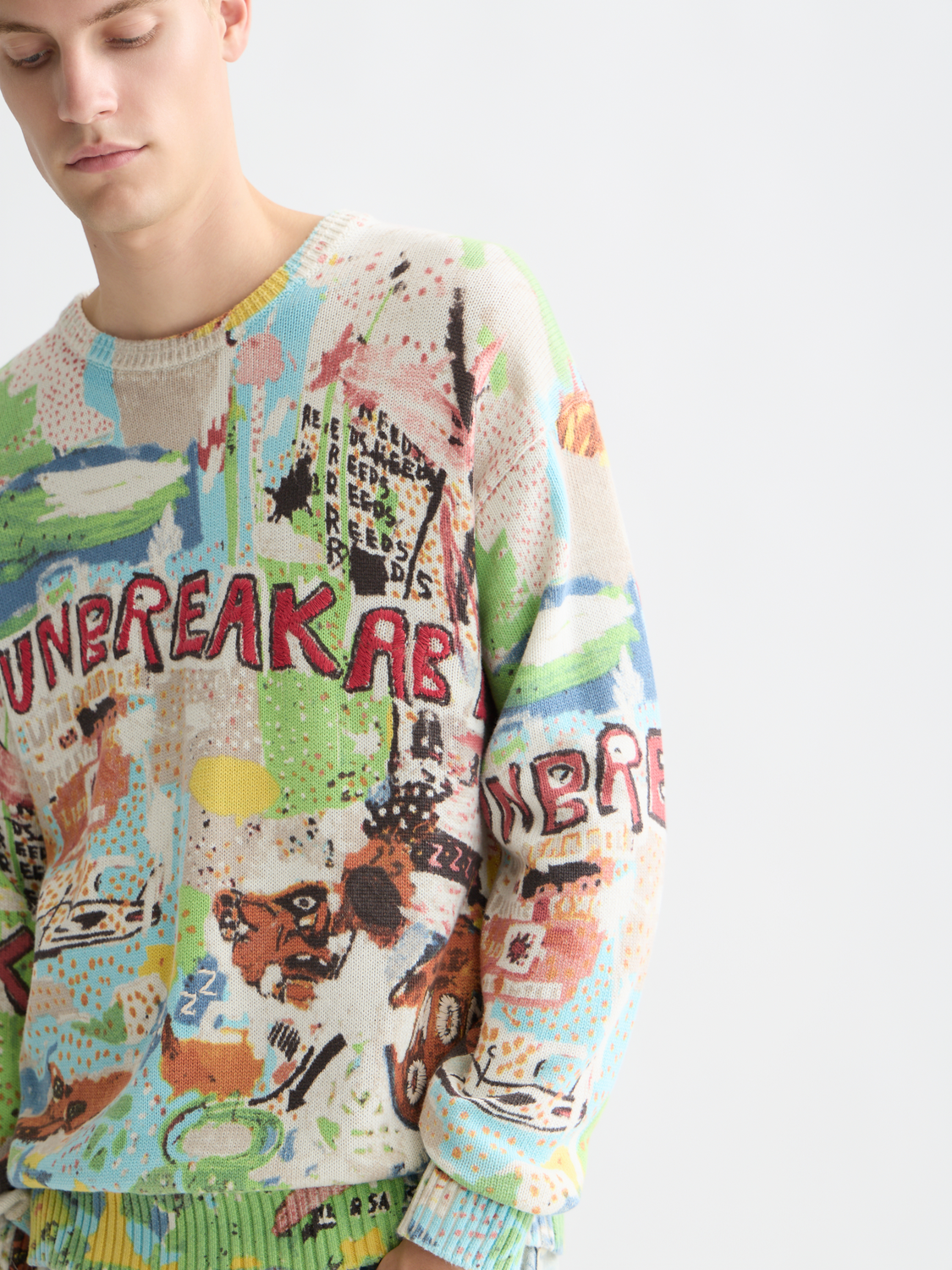 SCOTCH & SODA S&S x Basquiat printed knitwear pullover featuring colorful Basquiat artwork on soft fabric.