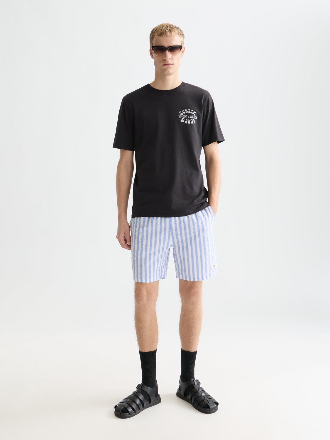 Striped mid-length Scotch & Soda swimwear shorts with blue, white, and red horizontal stripes, displayed flat on a white background.
