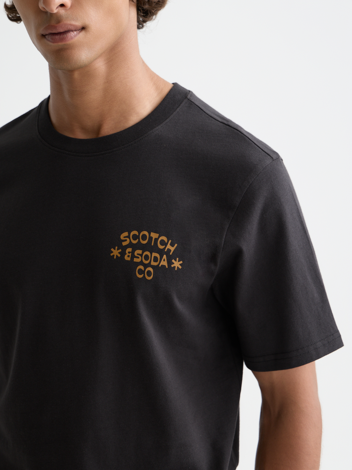 Black short-sleeve logo t-shirt from Scotch & Soda featuring a front graphic design and comfortable fit.