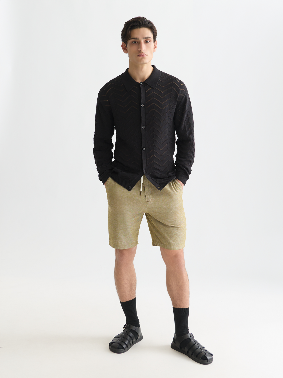 Pointelle knit cardigan by Scotch & Soda, featuring delicate openwork pattern and soft knit fabric, displayed on a plain background.