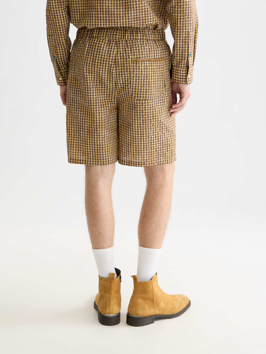 Light blue Scotch & Soda seersucker shorts with a relaxed fit, displayed on a model from the back.
