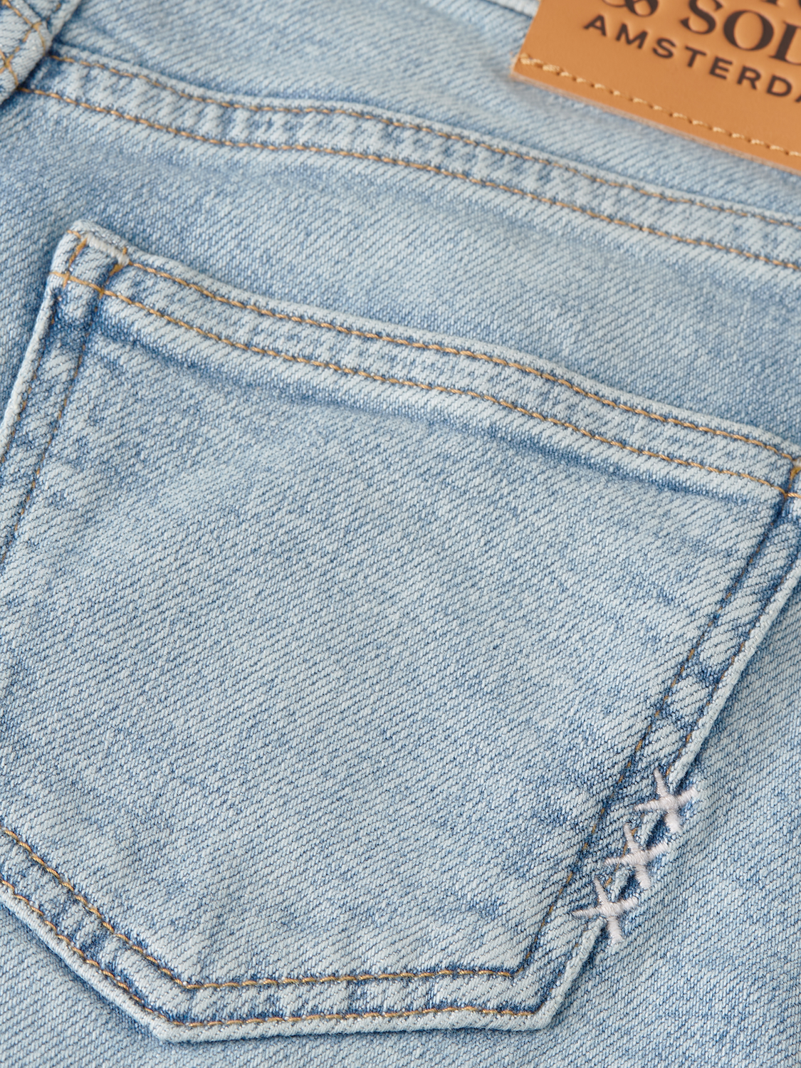 Kids' wave wide-fit denim jeans by Scotch & Soda, showing stylish blue denim with a relaxed fit and wave design.
