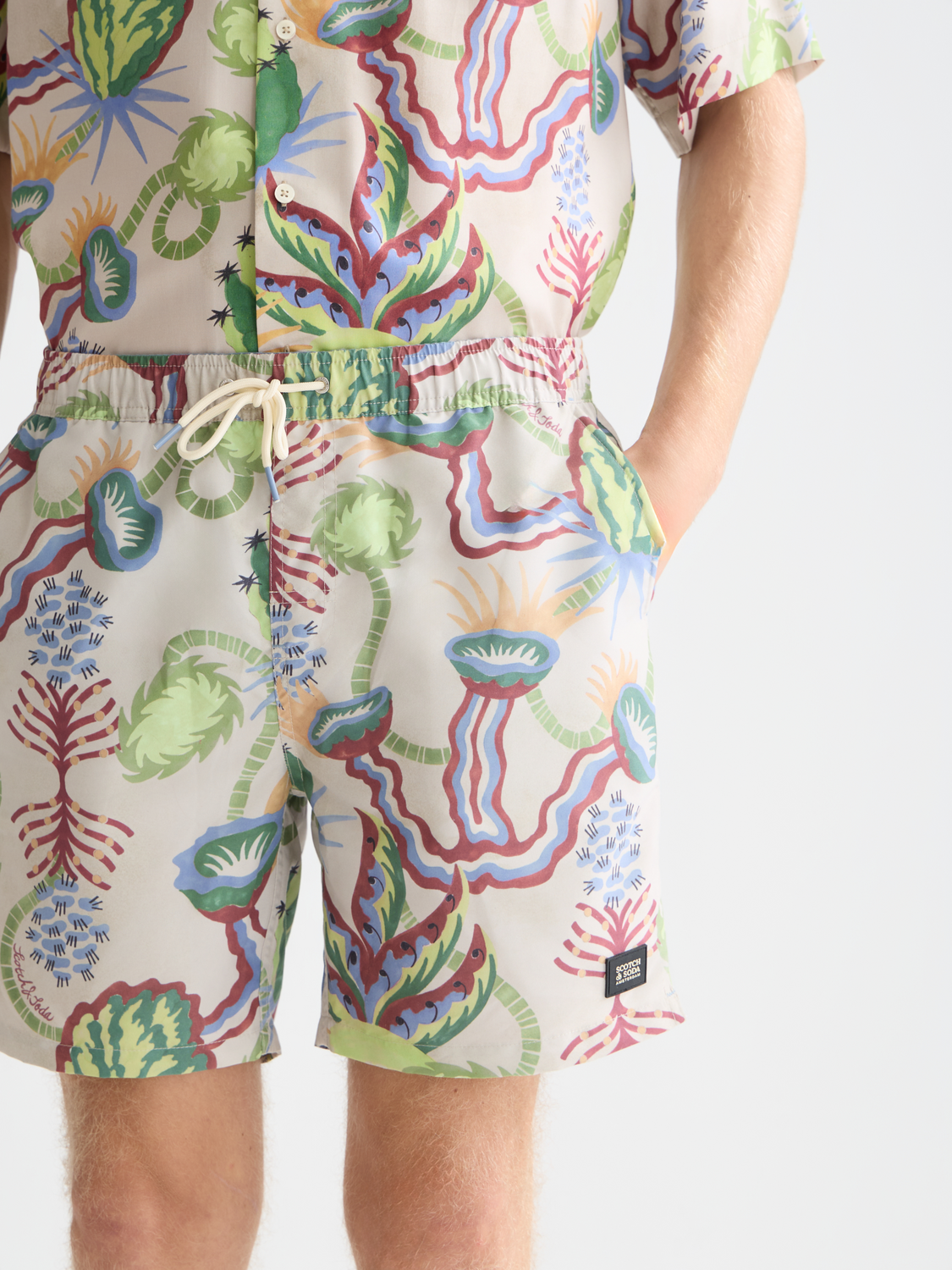 Printed swimshorts from Scotch & Soda, stylish men's swimwear with vibrant pattern, displayed on a plain background.