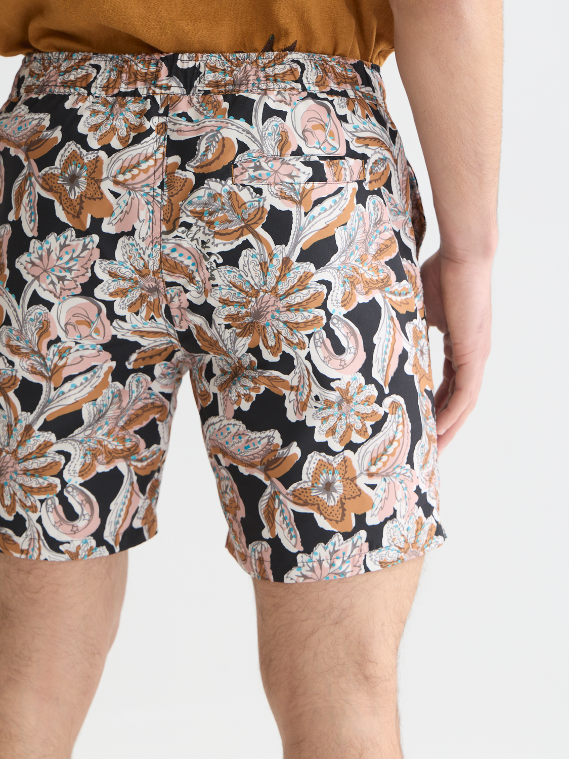 Printed swimshorts by Scotch & Soda featuring a vibrant tropical pattern, designed for comfortable beachwear and swimming.