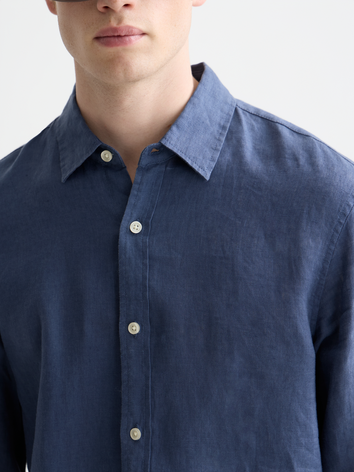 Long-sleeve linen shirt by Scotch & Soda, showing lightweight fabric, relaxed fit, and classic collar on model.