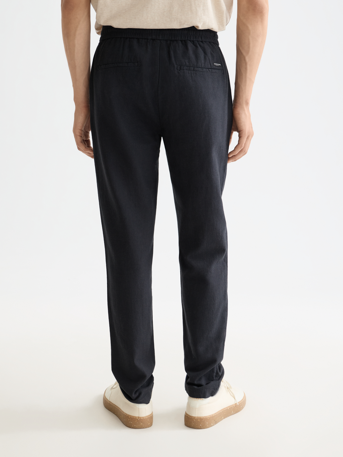 SCOTCH & SODA Warren joggers, navy pants with relaxed fit and elastic waistband, shown from back view.