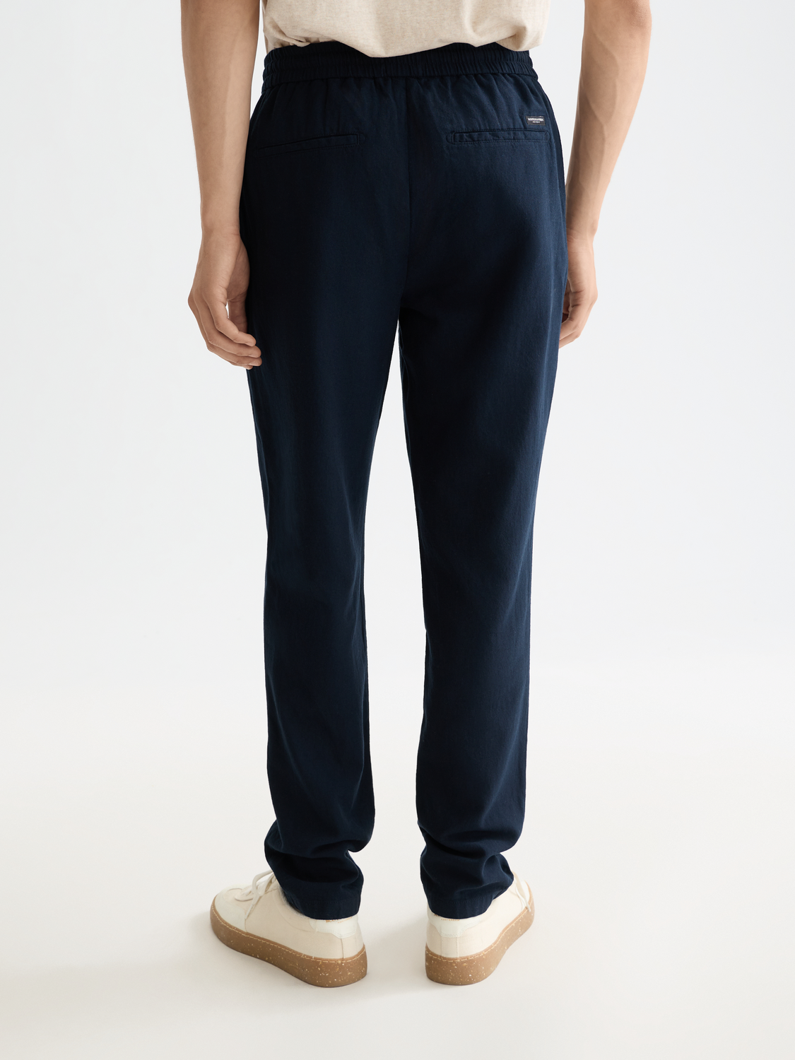 Scotch & Soda Warren jogger pants in dark gray with relaxed fit and elastic waistband, shown from back view.