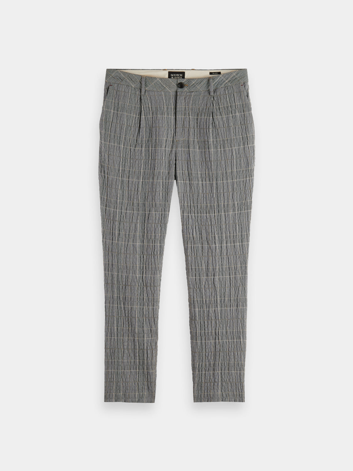 Scotch & Soda Blake slim fit chinos in a neutral color, shown folded with front pockets and belt loops.