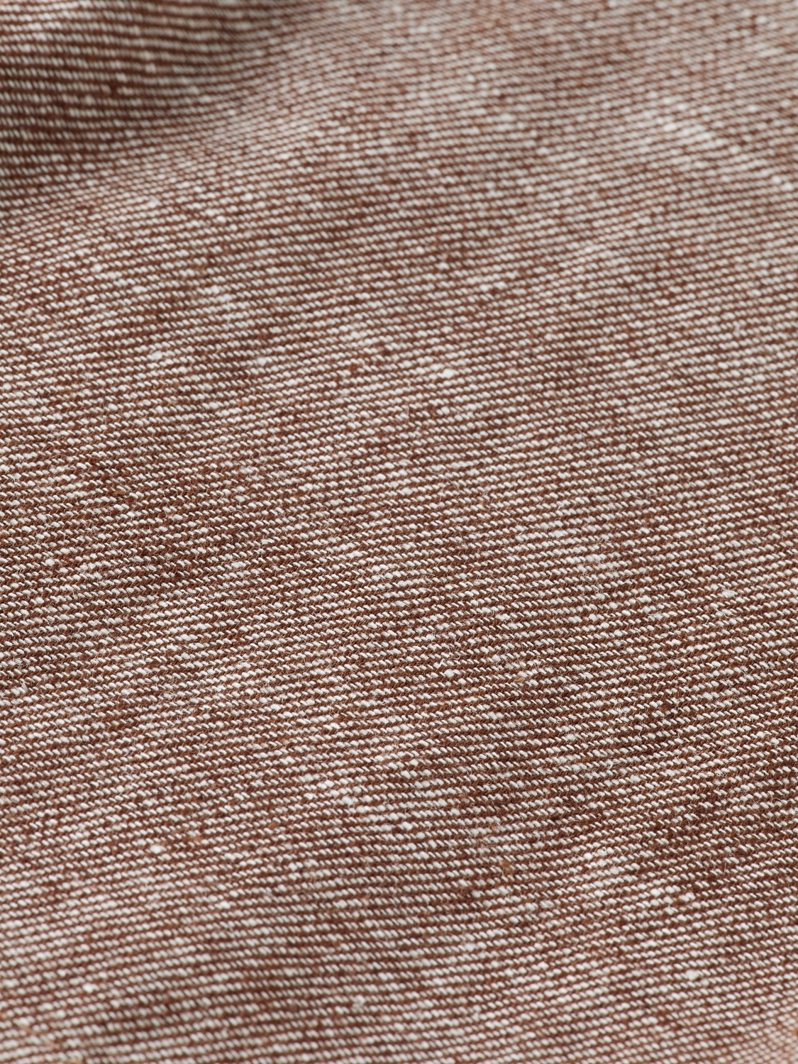 Pair of beige pleated shorts from Scotch & Soda with a high waist and relaxed fit, displayed on a neutral background.