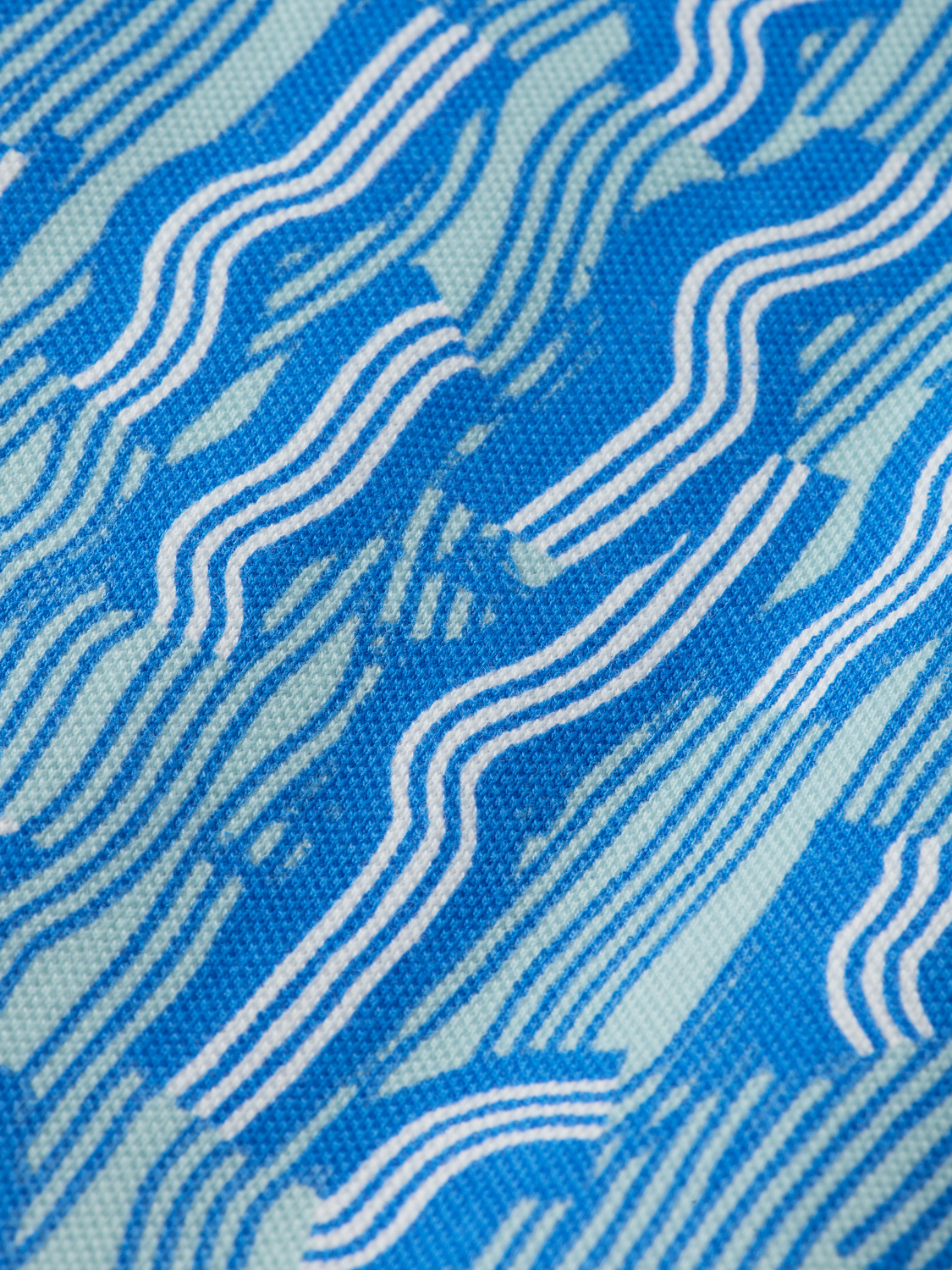 Printed Scotch & Soda polo shirt with colorful design, short sleeves, and classic collar for casual wear.