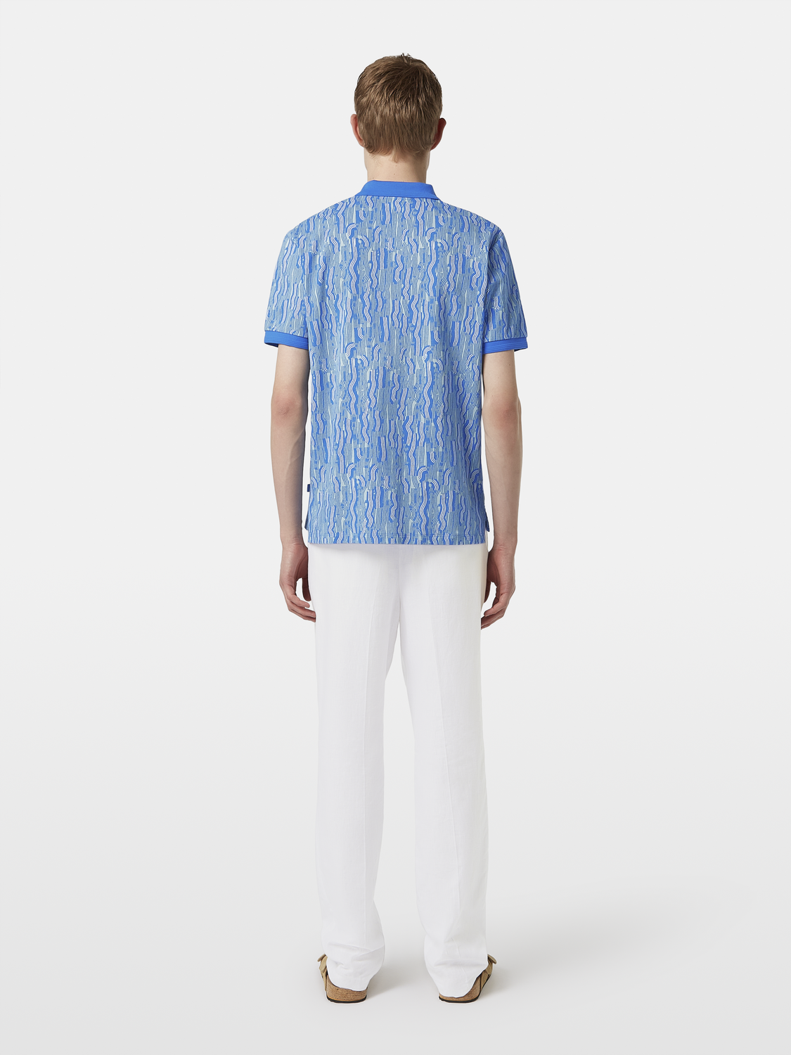 Black printed polo shirt from Scotch & Soda, featuring a stylish pattern and classic collar design.