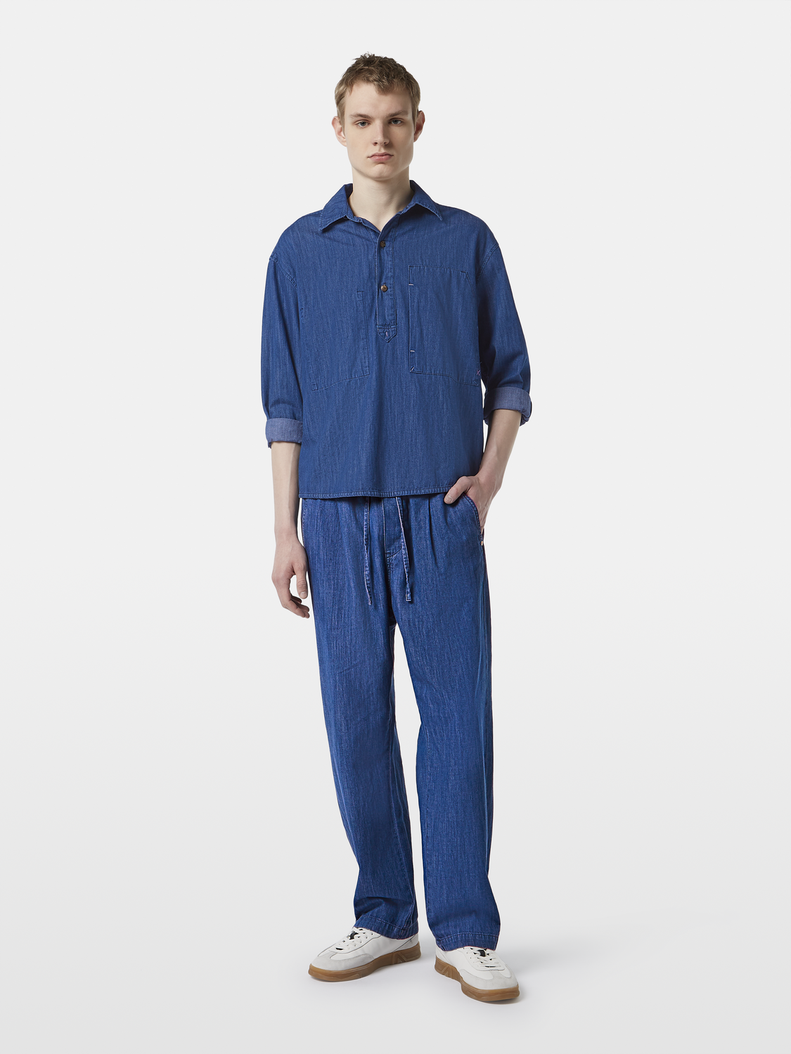 Lightweight denim pants by Scotch & Soda featuring classic fit and blue denim fabric, shown on a model.