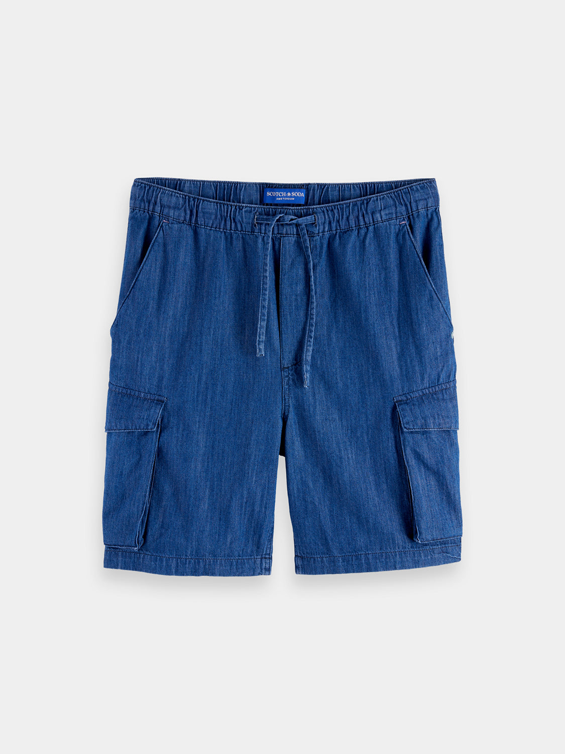 SCOTCH & SODA denim cargo shorts with multiple pockets, styled casually on a model for a trendy summer look.