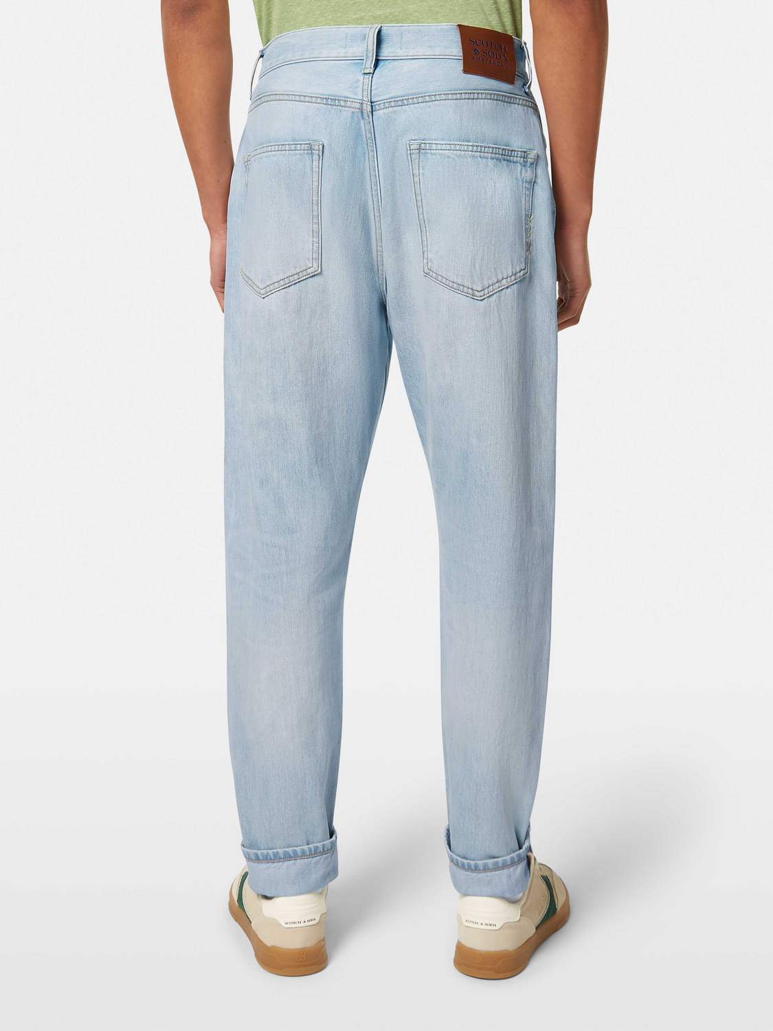 SCOTCH & SODA Dean tapered denim jeans displayed from the back, showing dark wash fabric and classic fit.
