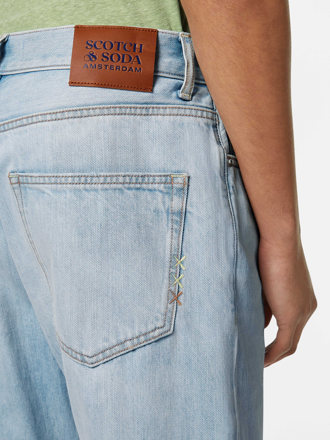 Scotch & Soda Dean tapered denim jeans displayed on a model, showcasing slim fit and classic blue color.