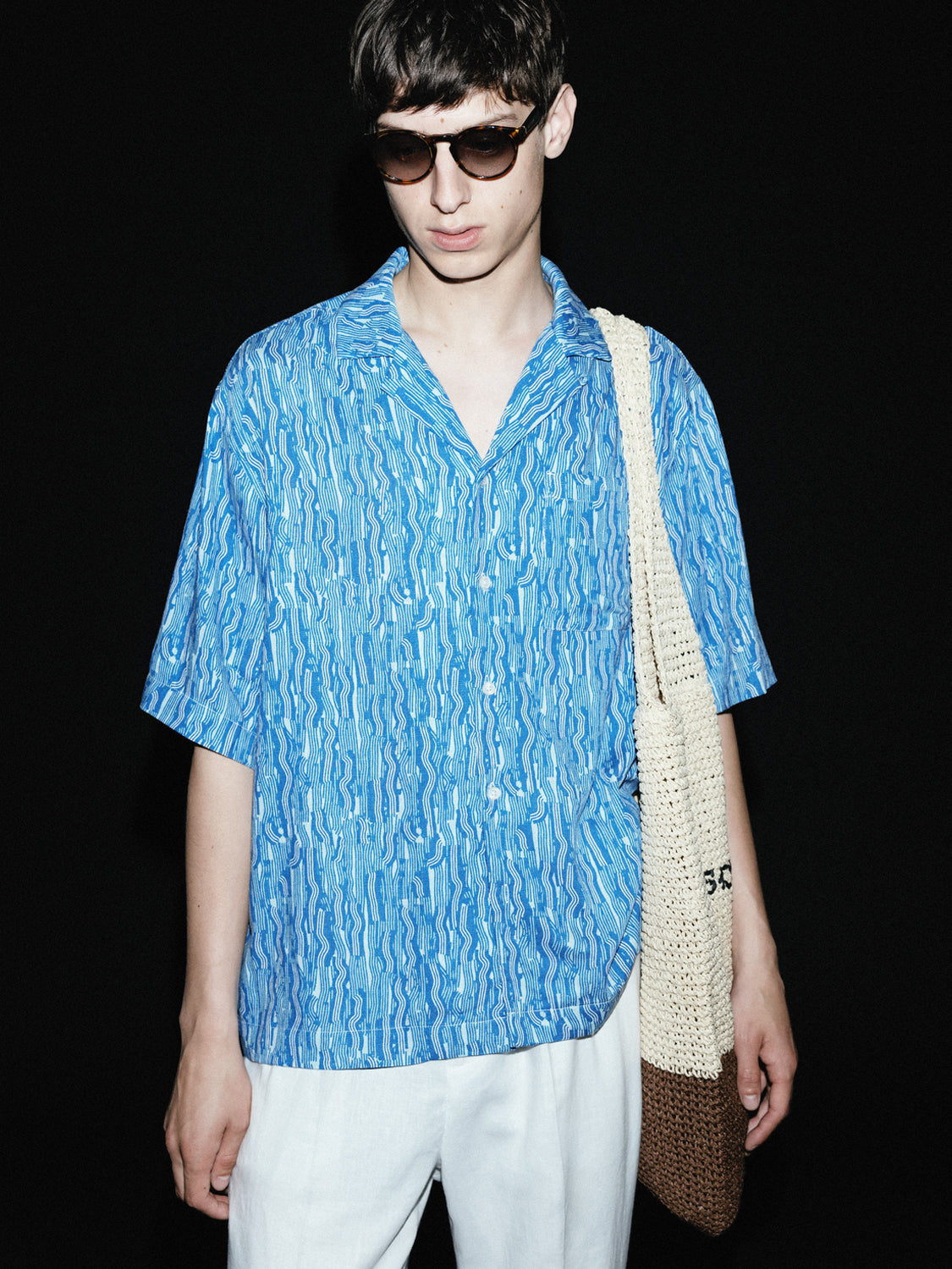 Short-sleeved printed shirt by Scotch & Soda featuring colorful floral pattern and casual fit.