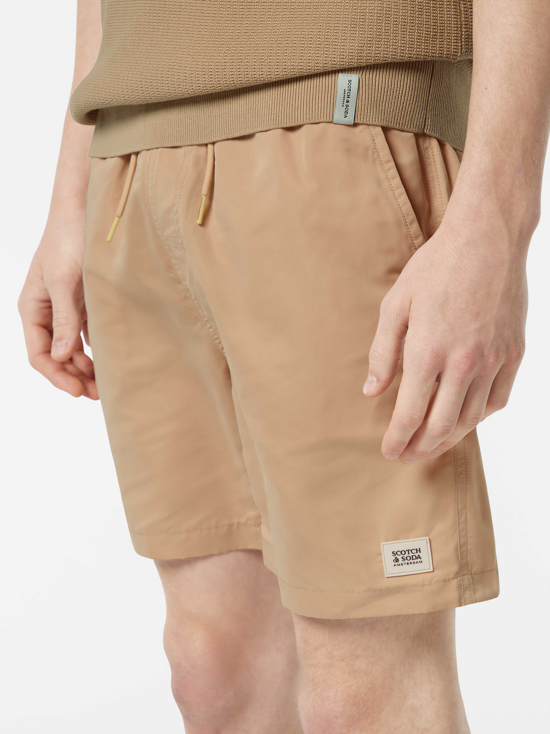 Mid-length Scotch & Soda swim shorts in vibrant print, featuring an elastic waistband and side pockets for beach or poolwear.