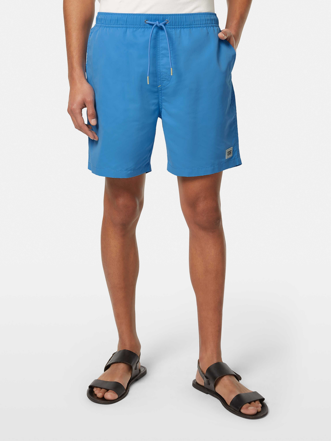 Mid-length Scotch & Soda swimshorts in coral color, featuring a relaxed fit, laid out on a neutral background.