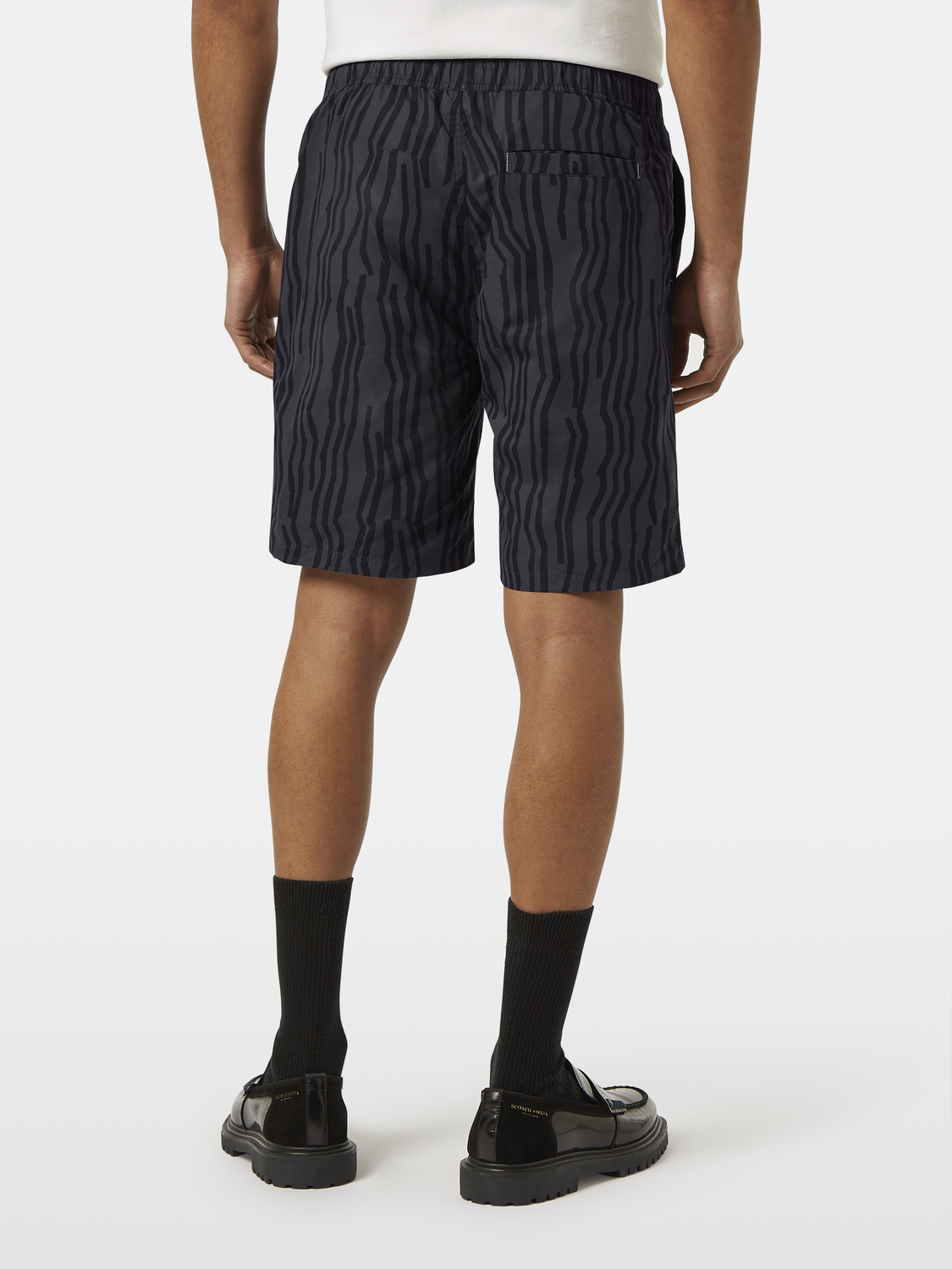 Printed swimshorts from SCOTCH & SODA featuring a vibrant pattern, displayed on a plain background.