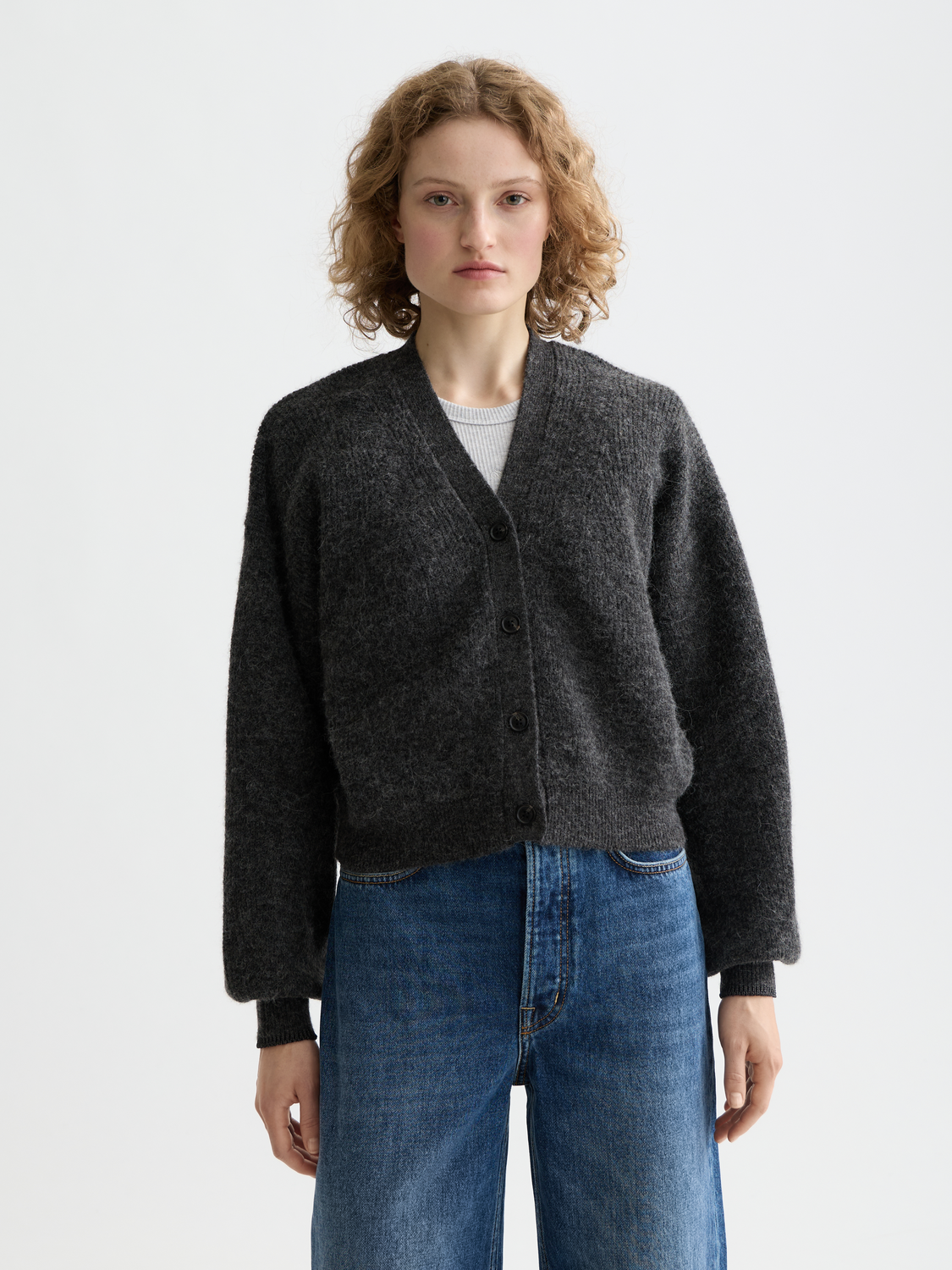 Close-up of a fuzzy knit cardigan by Scotch & Soda, featuring a cozy texture and front button design.