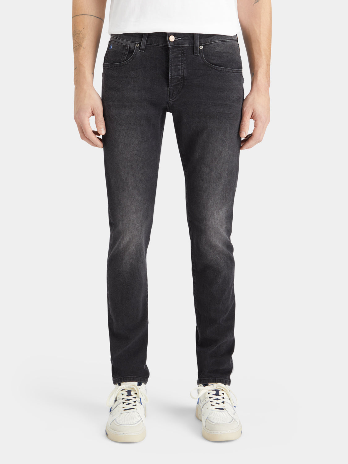 Slim-fit denim jeans by Scotch & Soda with a classic blue wash and five-pocket design, displayed on a model.