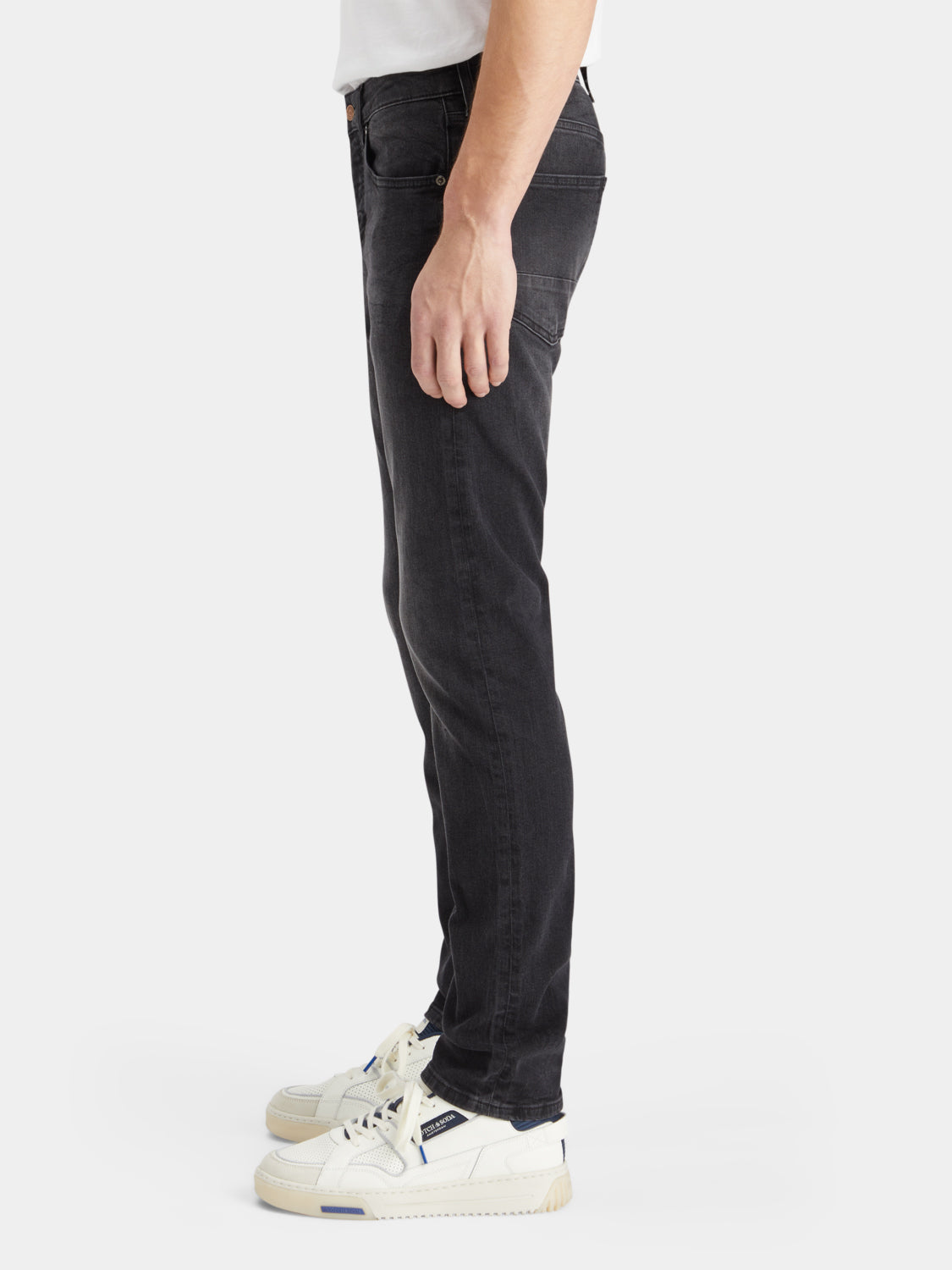 Slim-fit denim jeans by Scotch & Soda featuring classic five-pocket design and a dark indigo wash.