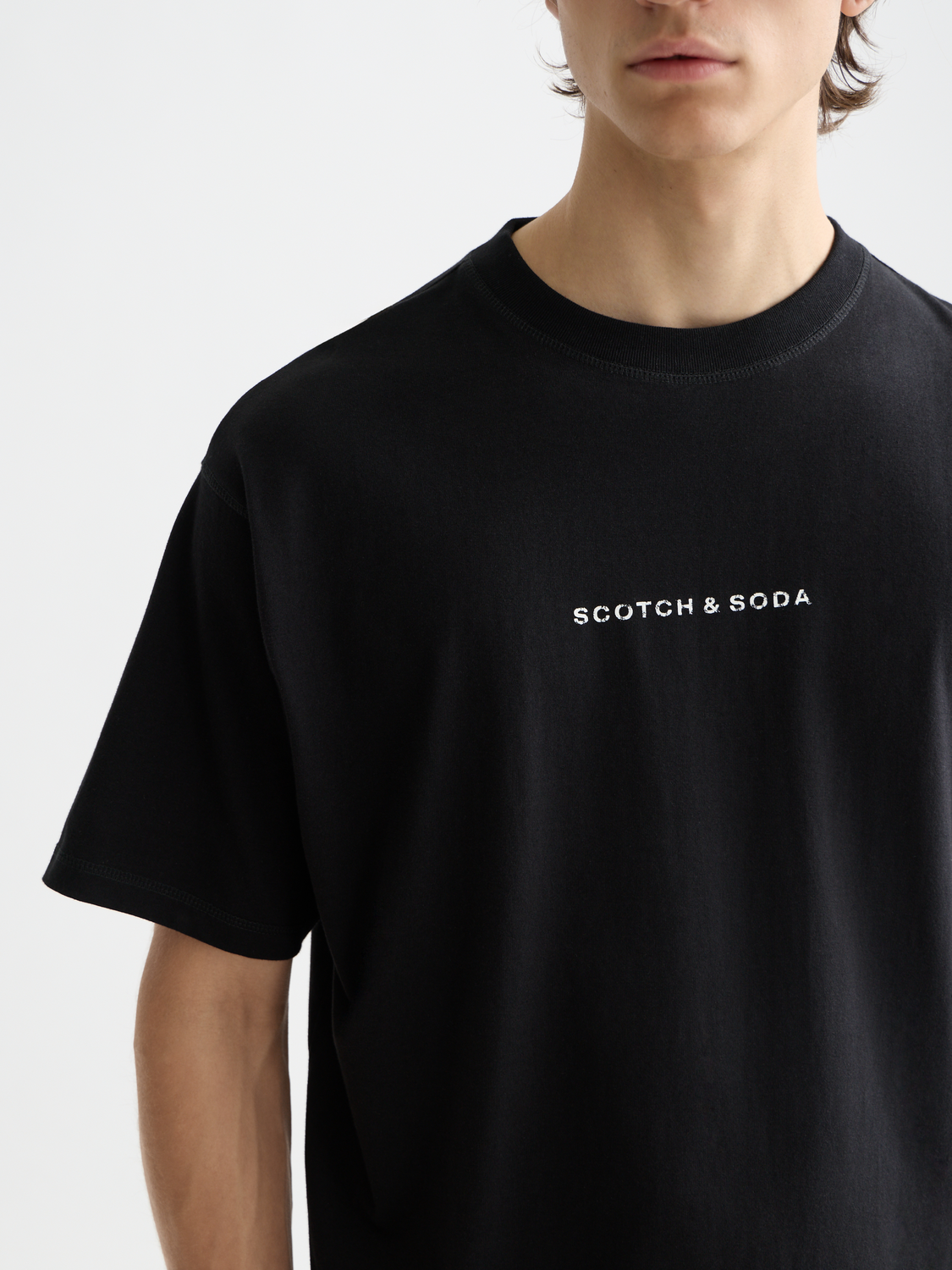 White short-sleeve logo t-shirt by Scotch & Soda featuring a minimalist design and a classic fit, displayed flat.