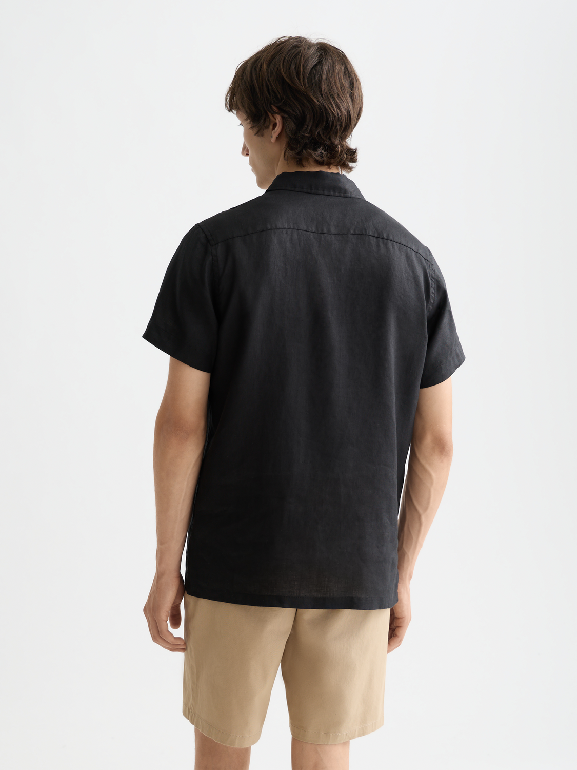 Back view of a Scotch & Soda short-sleeved linen shirt featuring a relaxed fit and natural fabric texture.