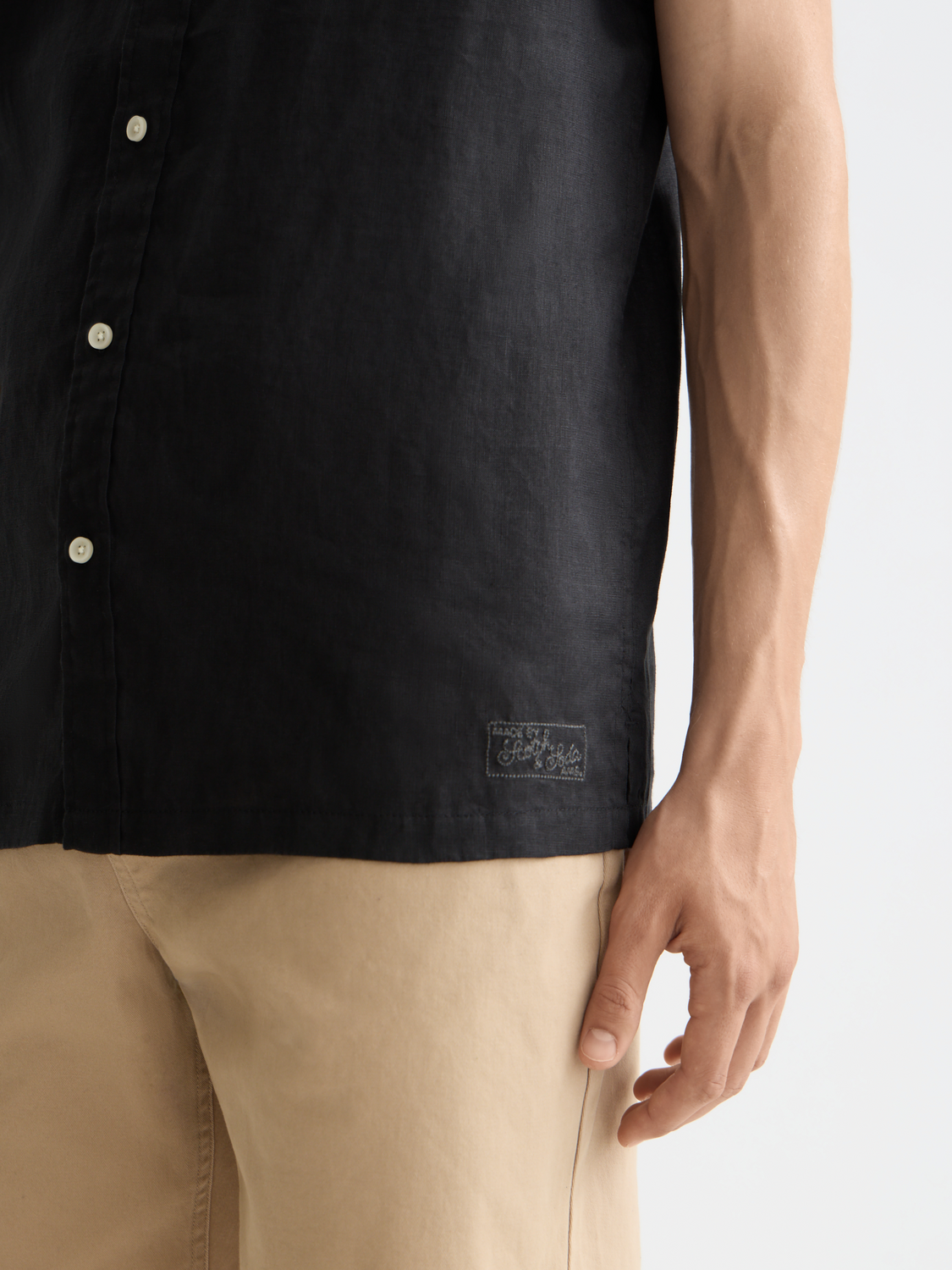 Short-sleeved linen shirt by Scotch & Soda featuring a relaxed fit and natural linen fabric, displayed on a hanger.