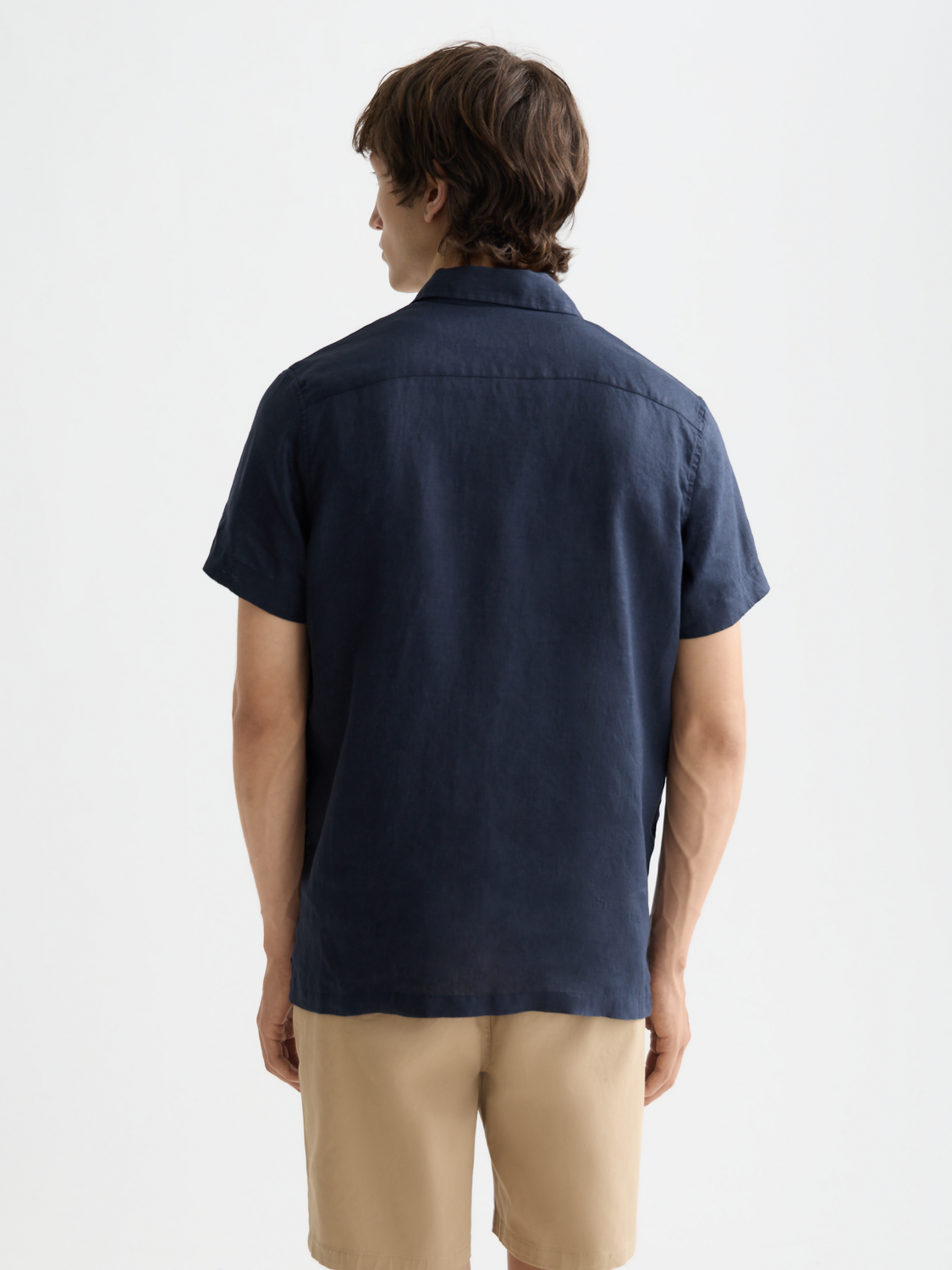 Short-sleeved linen shirt by Scotch & Soda, featuring a relaxed fit, lightweight fabric, and a classic collar in deep blue color.