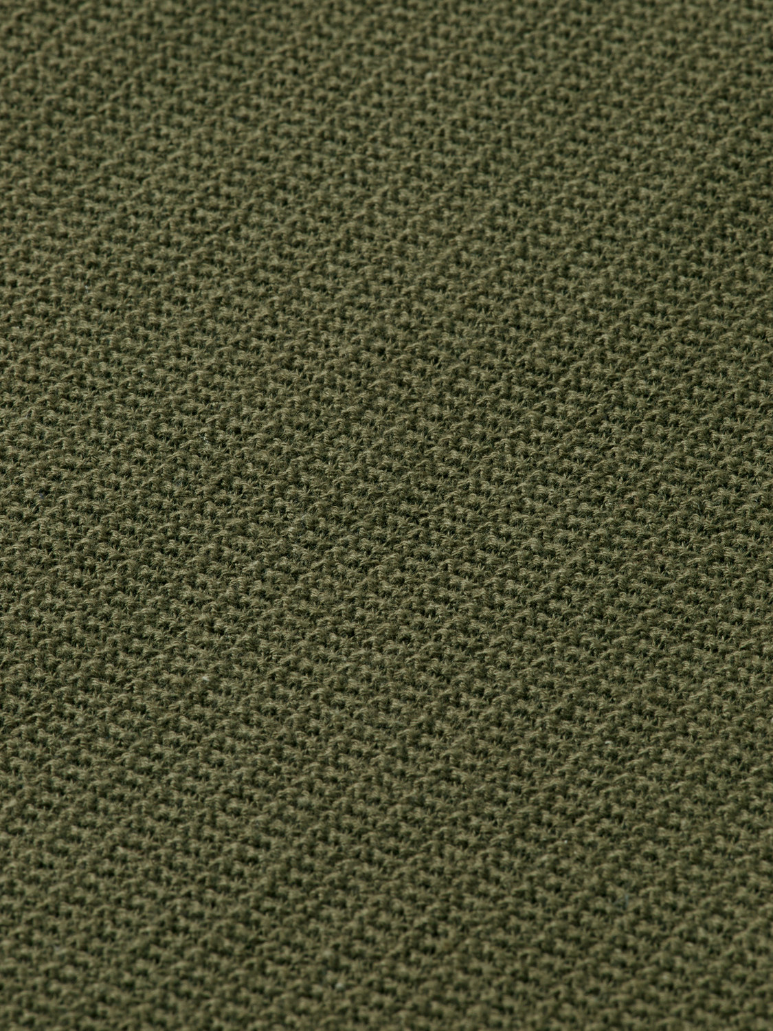 Blue knitted polo shirt from Scotch & Soda with a classic collar and textured fabric, displayed on a neutral background.
