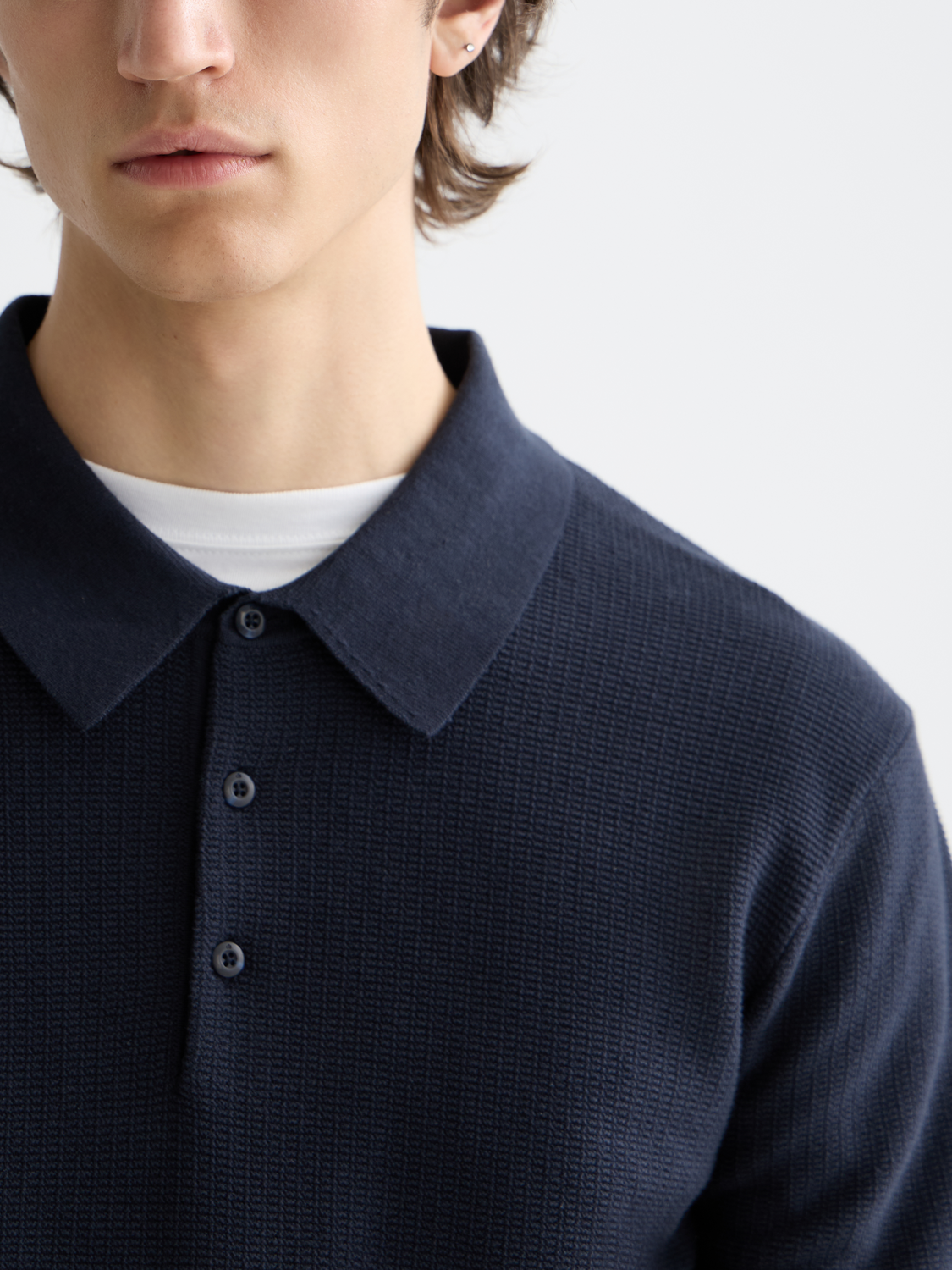 Knitted polo shirt by Scotch & Soda, featuring a classic collar, button placket, and textured knit fabric.