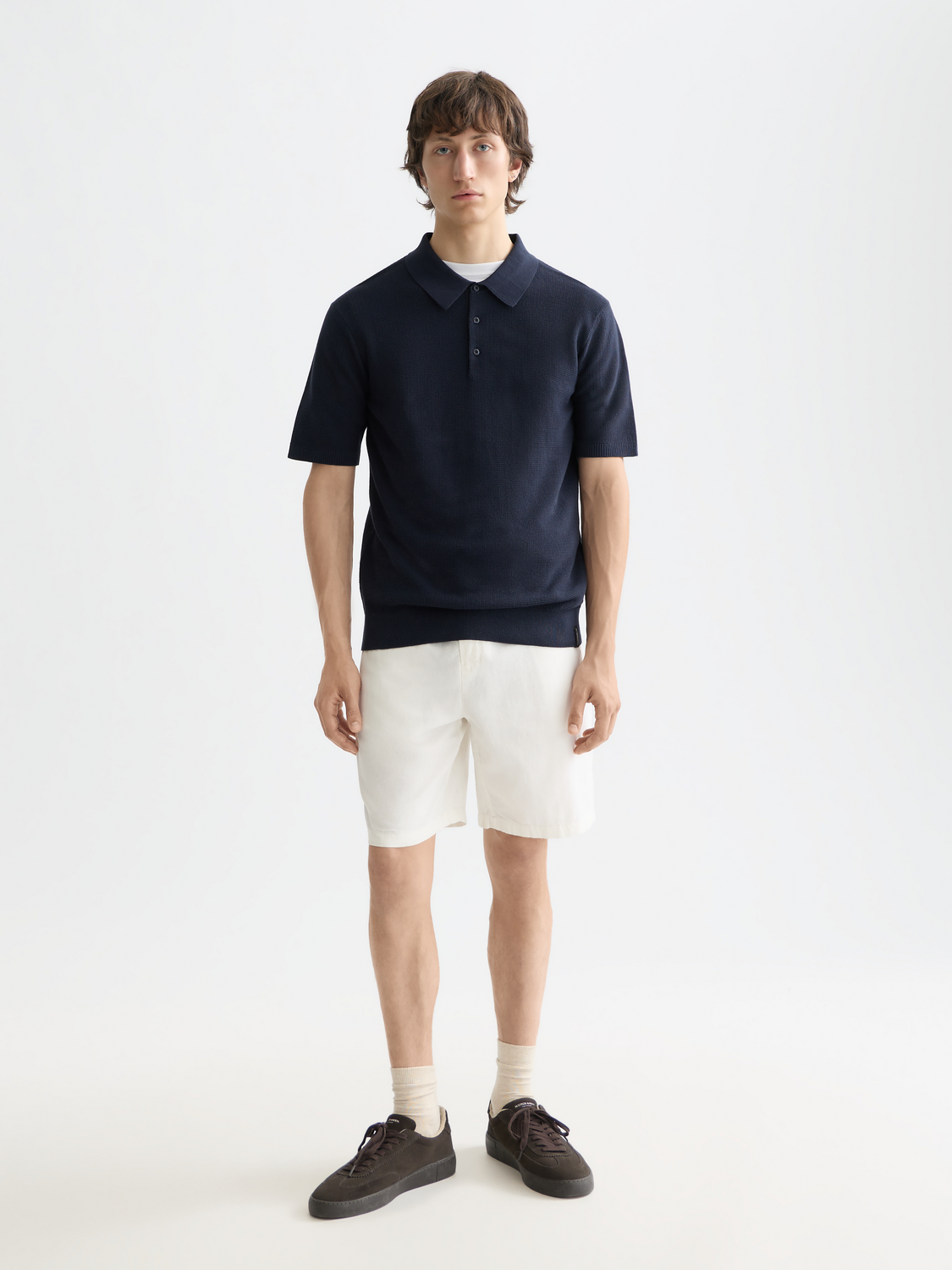 Knitted polo shirt by Scotch & Soda, featuring a classic collar and textured knit fabric, shown in a front view.