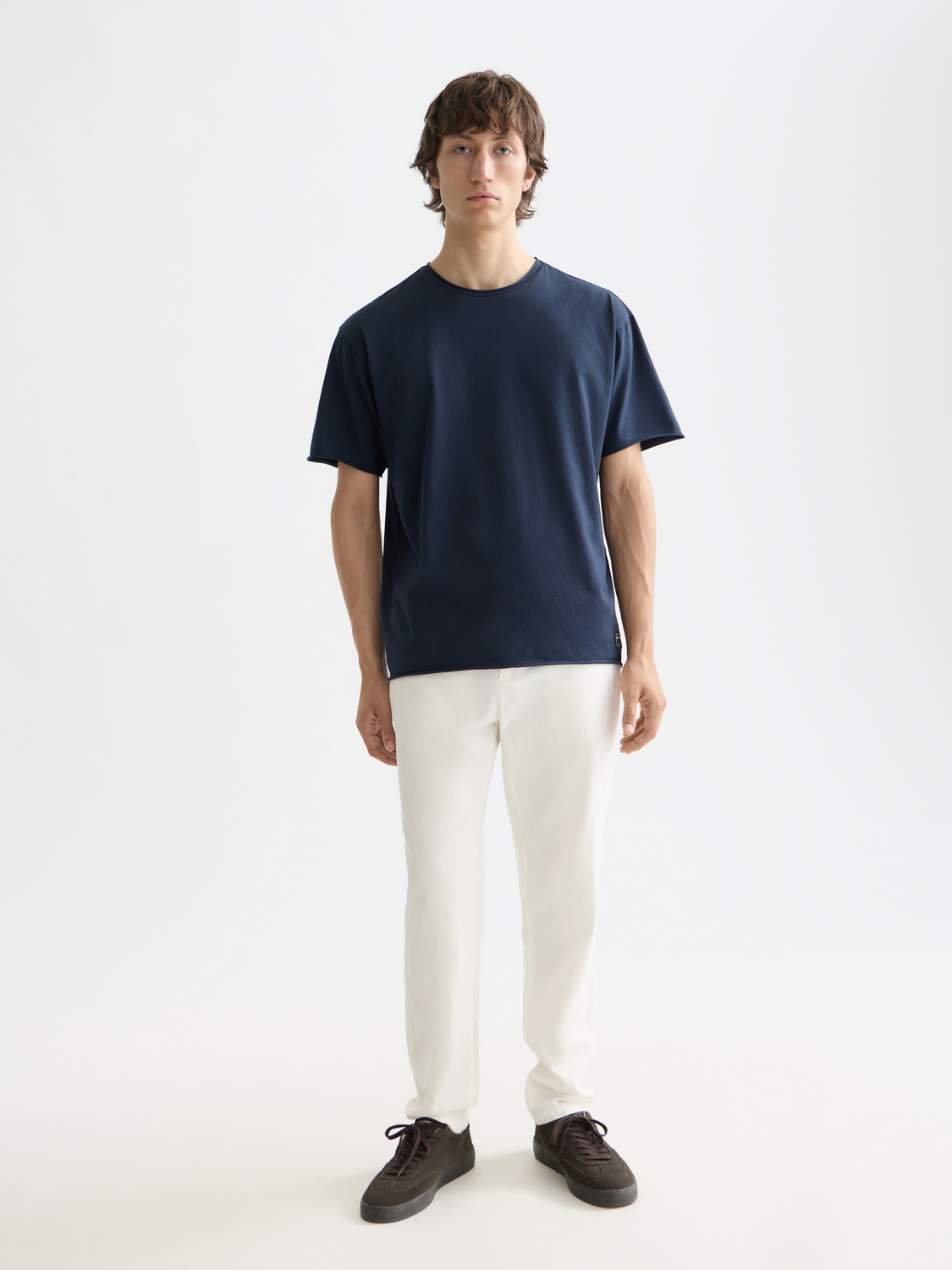 Raw-edged SCOTCH & SODA short-sleeve T-shirt with a casual fit and distressed hem, shown in a natural fabric texture and color.