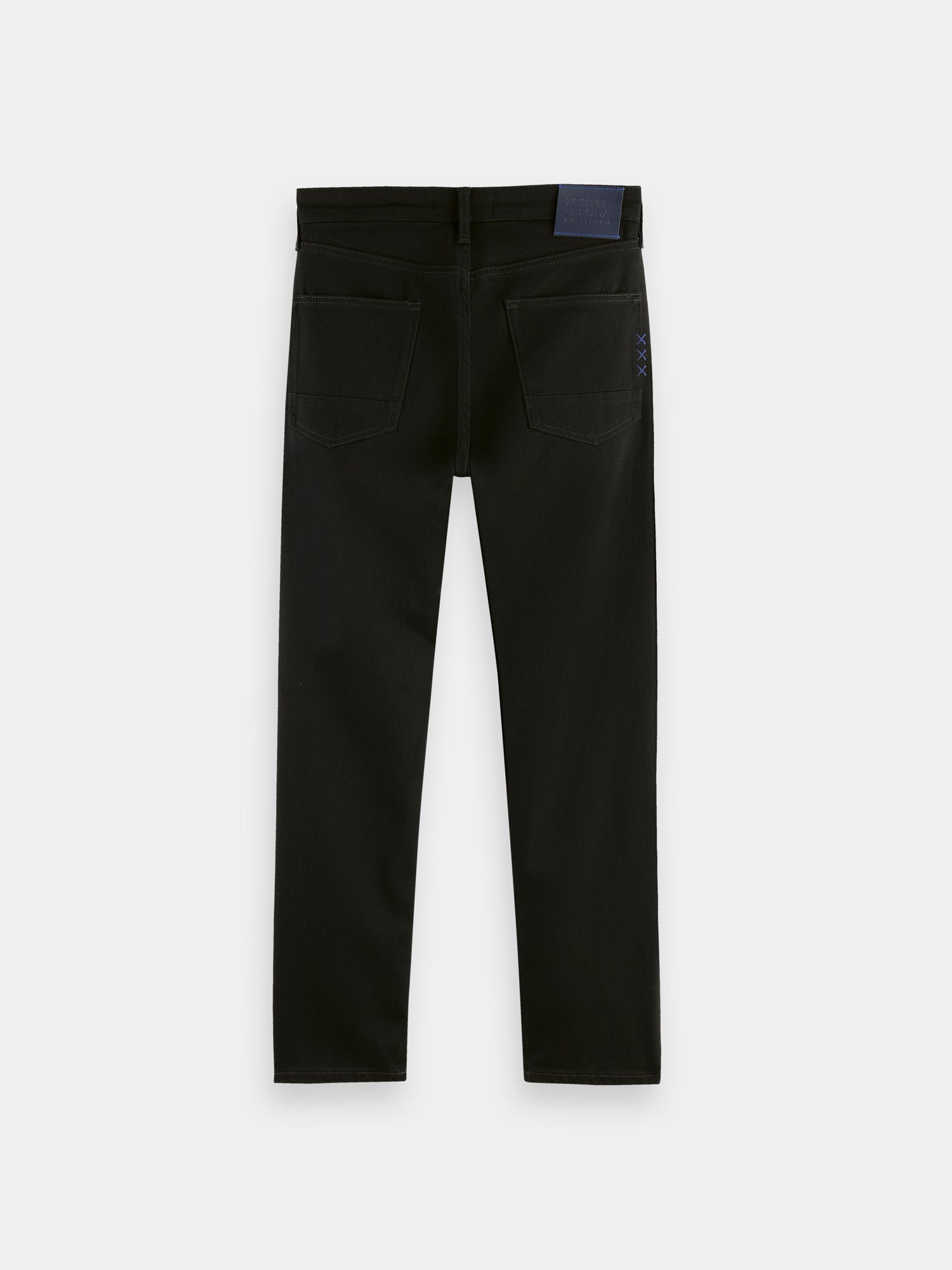 Dark blue Scotch & Soda Ralston slim fit denim jeans displayed on a hanger, showcasing classic five-pocket design and clean stitching.