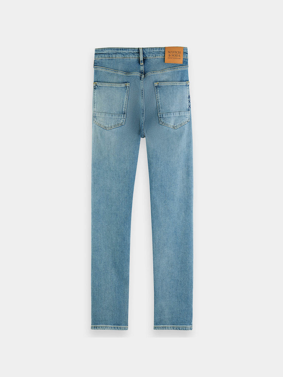 Dark blue Scotch & Soda Ralston slim fit denim jeans displayed on a hanger, showcasing the classic five-pocket design.