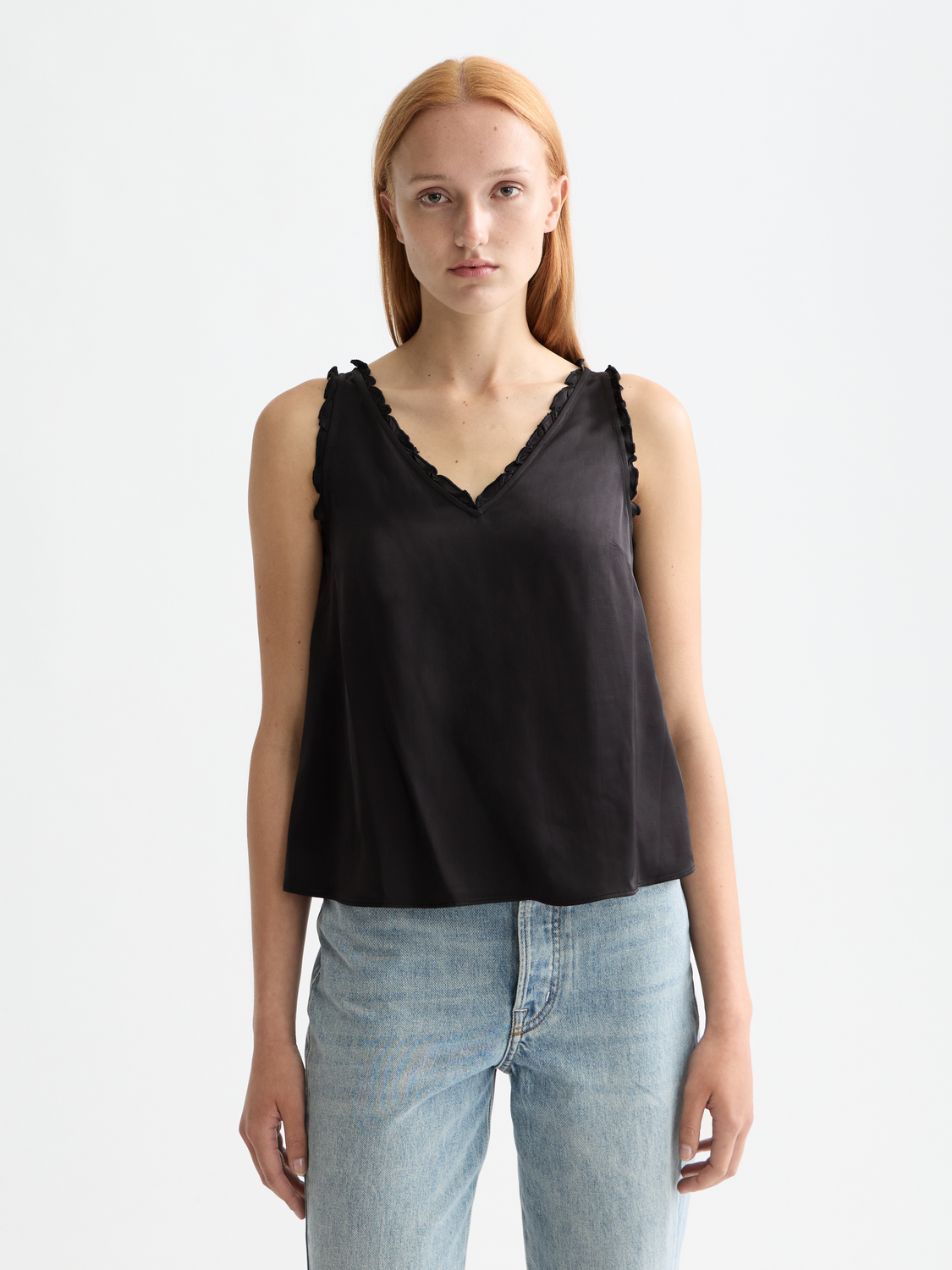 V-neck ruffle tank top from Scotch & Soda, sleeveless design with ruffle details, in soft fabric, styled on a model.