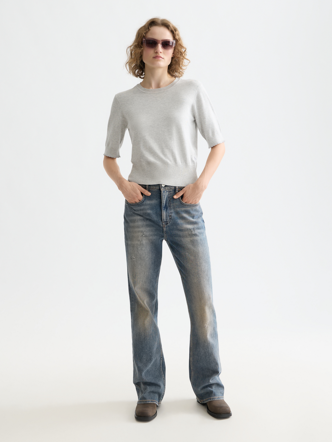 Short-sleeved knit pullover top by Scotch & Soda, showing a close-up of the soft fabric and classic design.